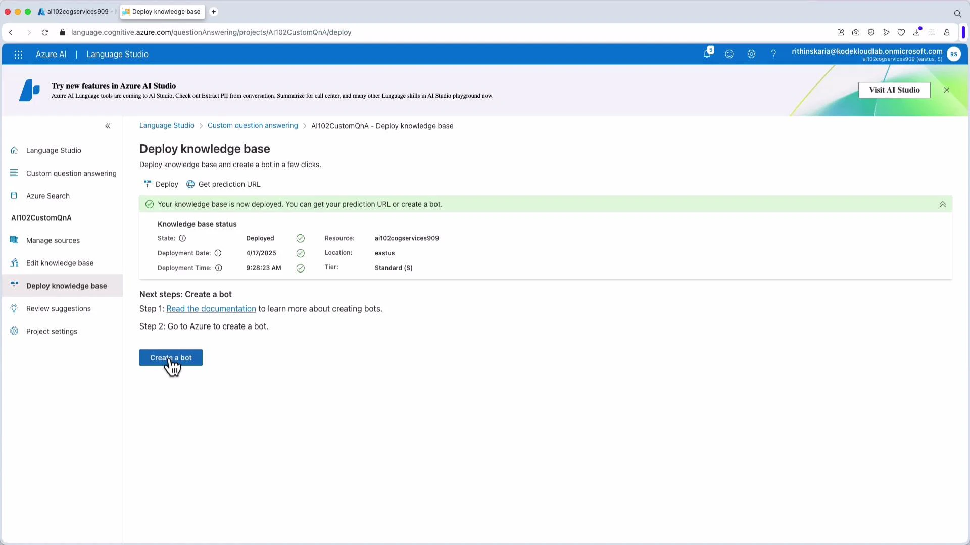 A screenshot of Azure AI Language Studio's "Deploy knowledge base" page showing a knowledge base successfully deployed. It shows deployment details (resource, location, date/time) and a "Create a bot" button with a hand cursor.