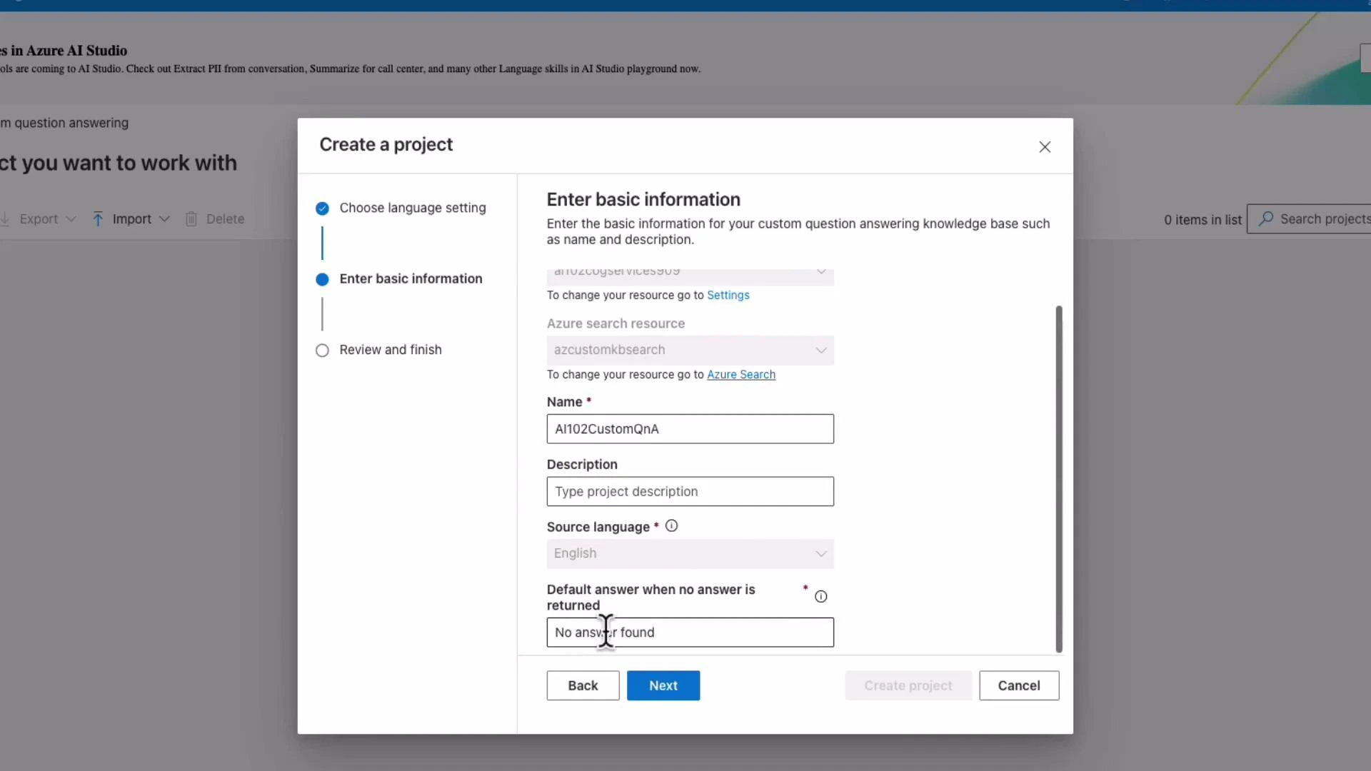 A "Create a project" modal from Azure AI Studio showing the "Enter basic information" step with fields for Name (AI102CustomQnA), Description, Source language, and a default answer set to "No answer found." At the bottom are Back, Next, and Cancel buttons.