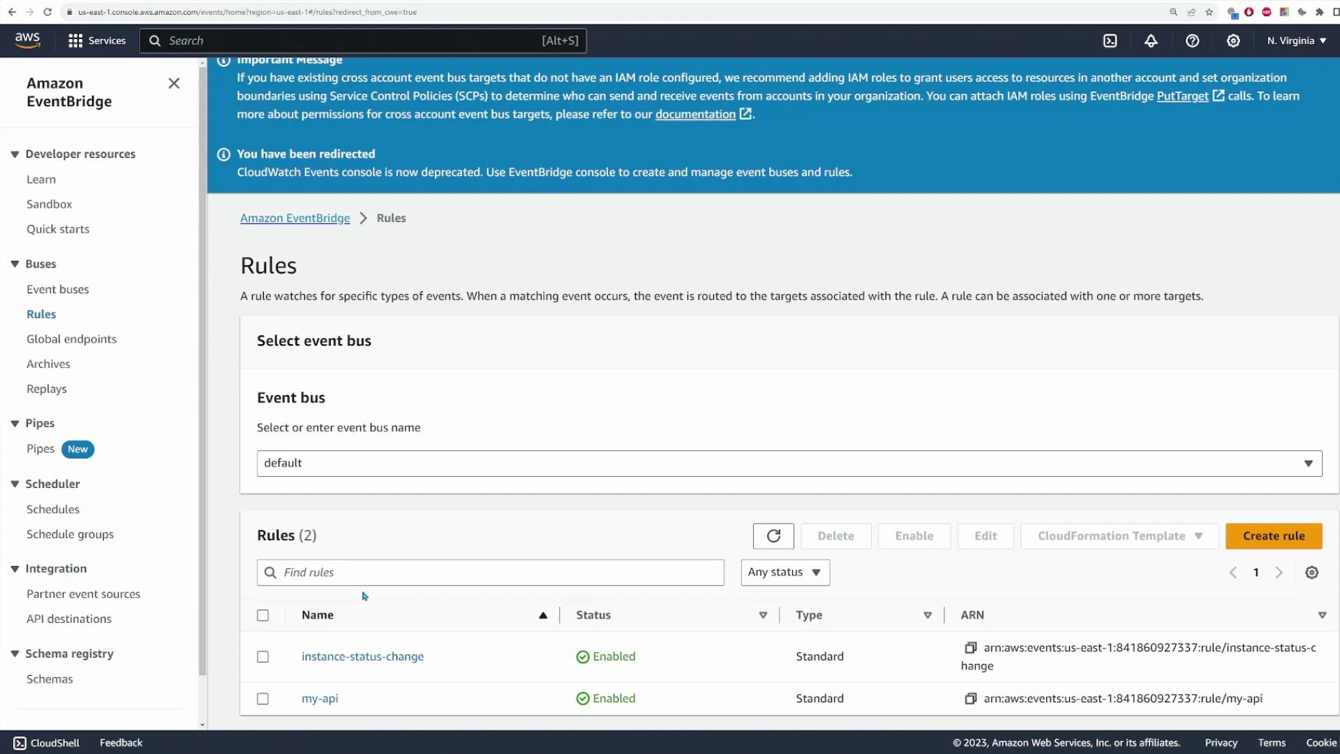 A screenshot of the Amazon EventBridge console on the Rules page with the event bus set to "default." The rules table shows two enabled rules, "instance-status-change" and "my-api," with their ARNs listed.