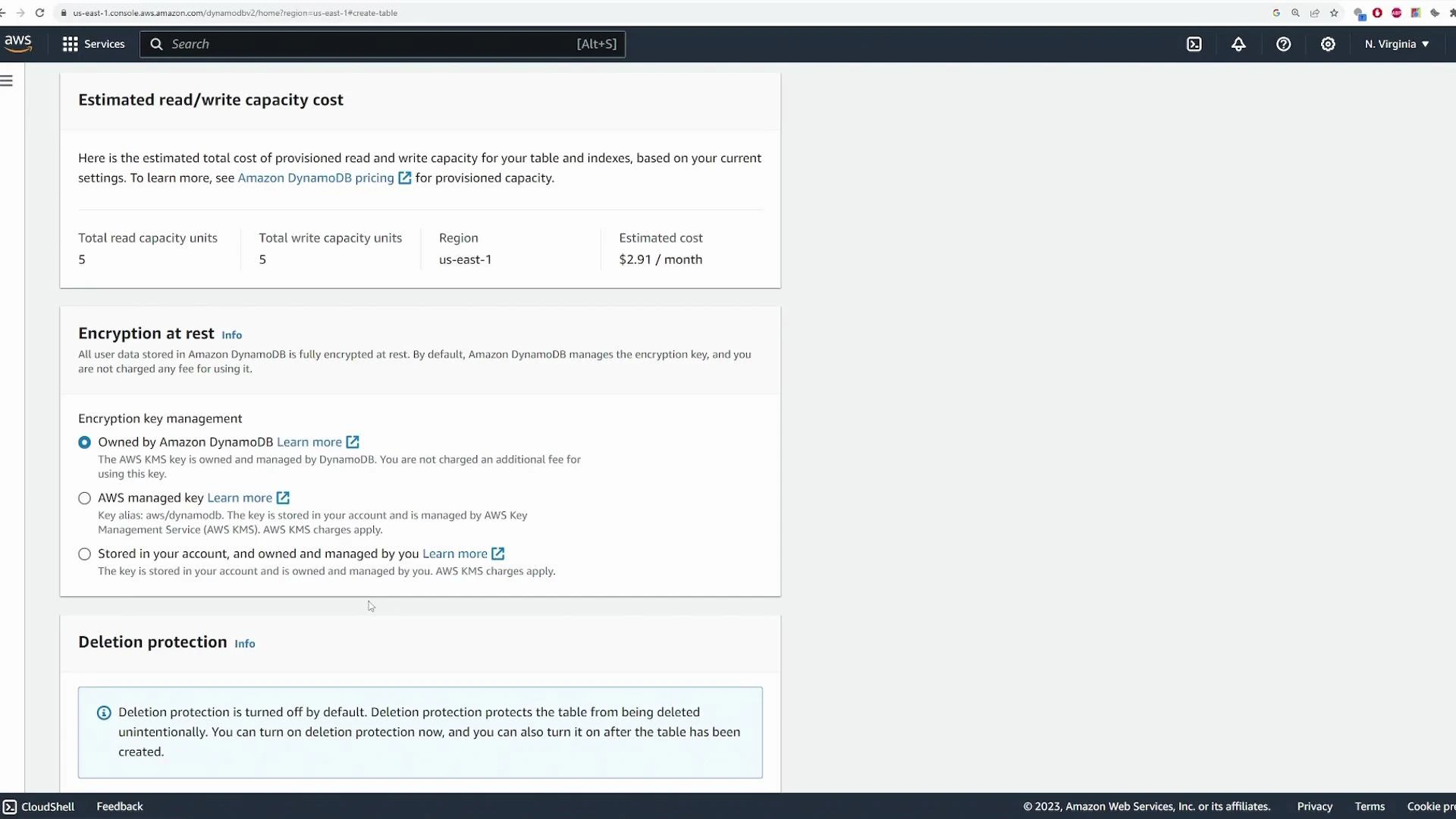 A screenshot of the AWS DynamoDB console's Create Table settings showing estimated read/write capacity cost, encryption-at-rest key management options, and deletion protection information. The page shows region us-east-1 and an estimated cost of $2.91/month.