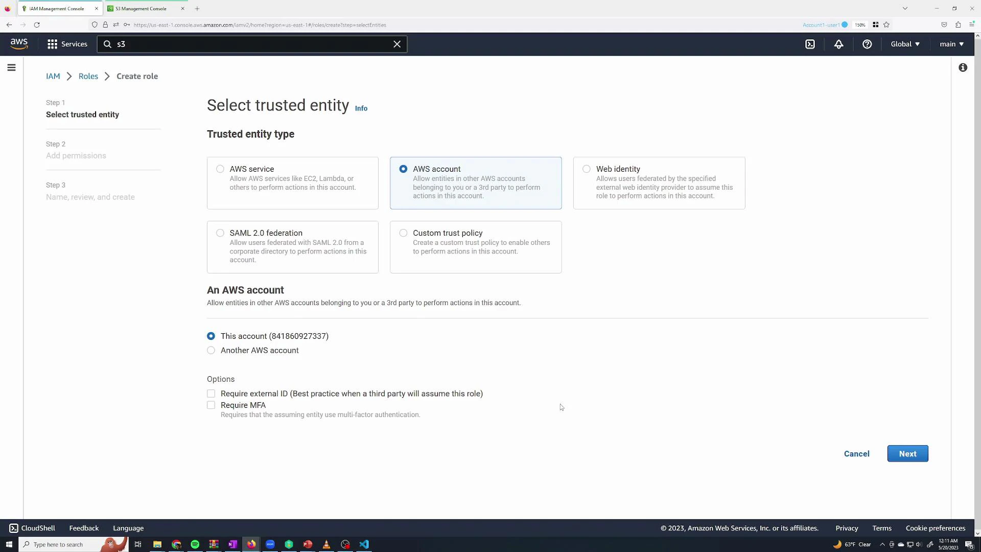 Screenshot of the AWS IAM console on the "Select trusted entity" step of creating a role, with the "AWS account" option selected and "This account" radio button checked. The page shows options like AWS service, Web identity, SAML 2.0, and Custom trust policy, with Cancel and Next buttons at the bottom.