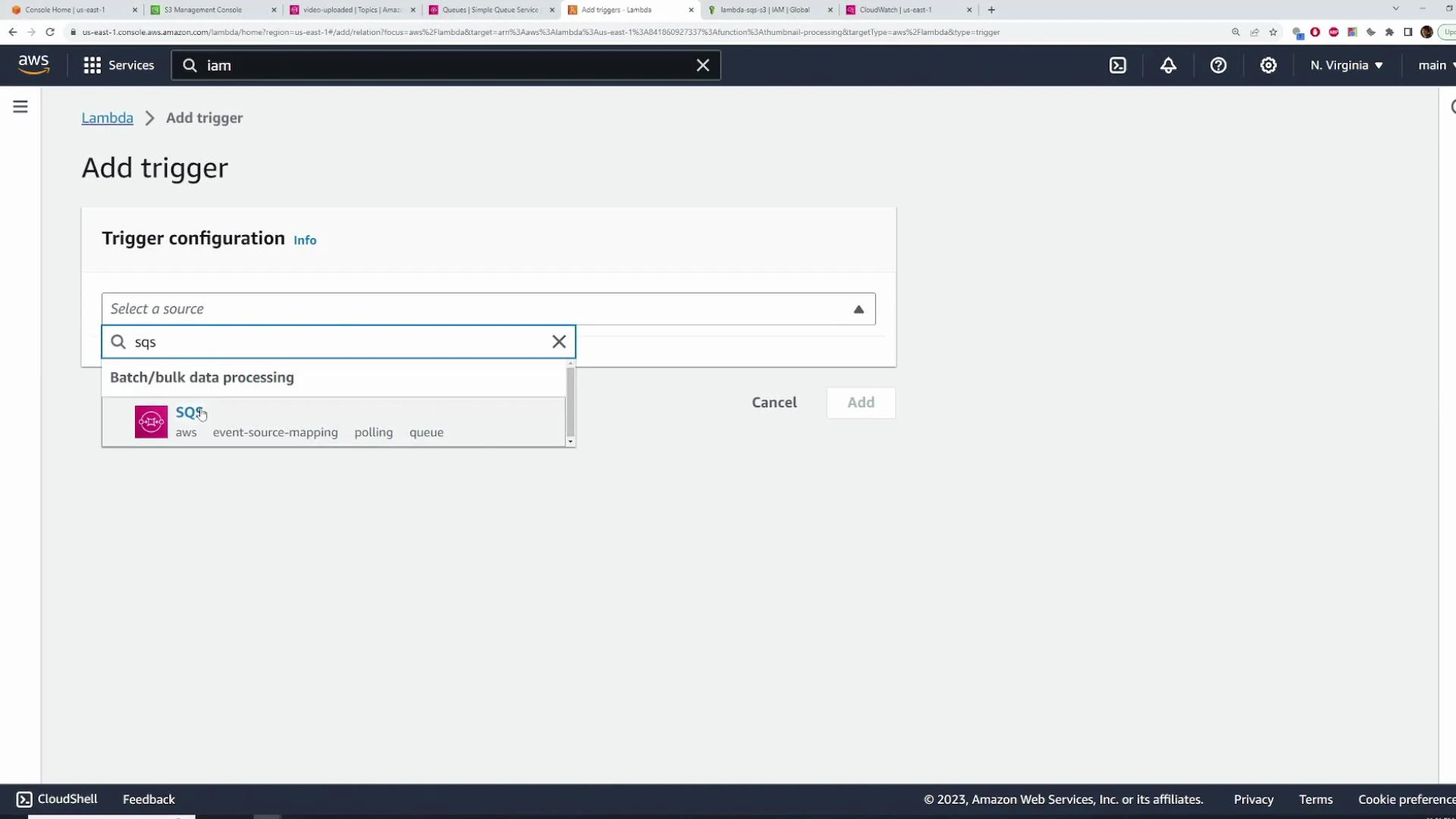 A screenshot of the AWS Lambda "Add trigger" page showing the Trigger configuration panel, with "sqs" typed into the source search and the SQS trigger option displayed. The page includes Cancel and Add buttons and the AWS console header.