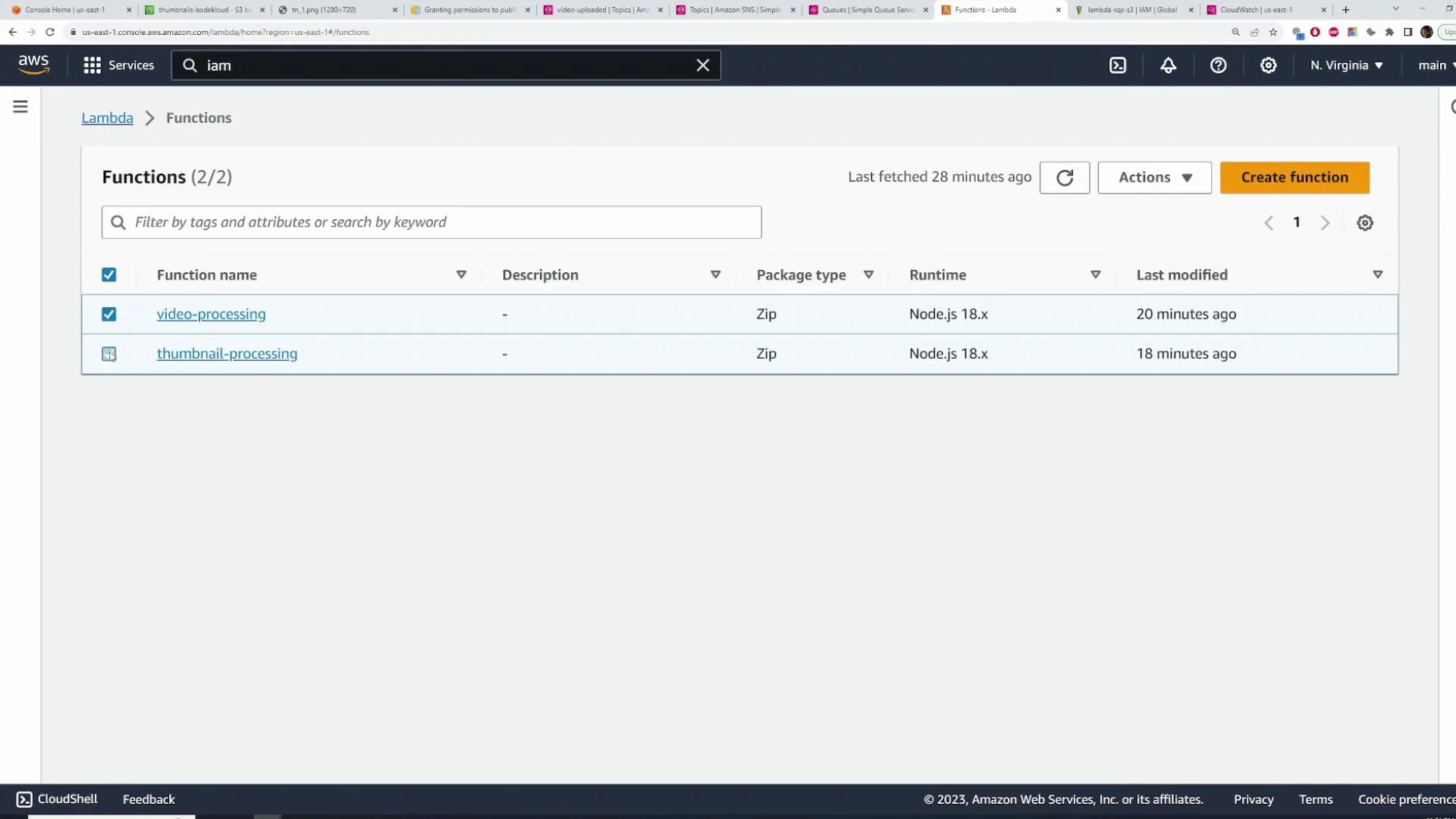 A screenshot of the AWS Lambda Functions page showing two functions, "video-processing" and "thumbnail-processing", both packaged as Zip and running Node.js 18.x. The table also shows last-modified times (20 minutes and 18 minutes ago) and UI controls like Create function and Actions.