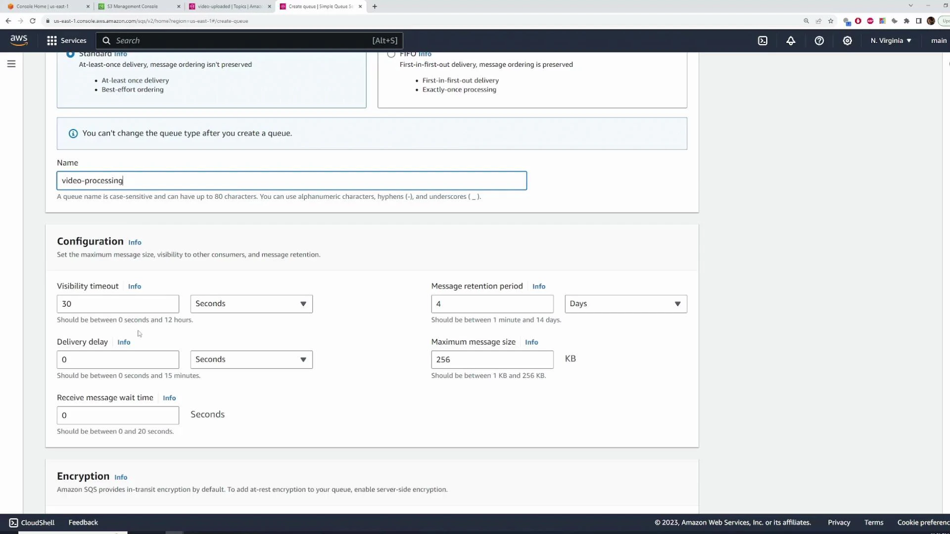 A screenshot of the AWS Management Console showing the Amazon SQS "Create queue" page with the queue name set to "video-processing" and configurable fields like visibility timeout, delivery delay, message retention period, and maximum message size. The browser tabs and AWS footer/CloudShell bar are also visible.
