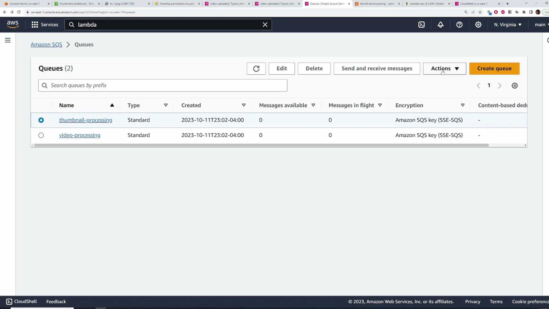 A screenshot of the AWS Management Console showing the Amazon SQS "Queues" page with two queues listed: "thumbnail-processing" and "video-processing" (both Standard). Both queues show zero messages and use Amazon SQS key (SSE-SQS) encryption.