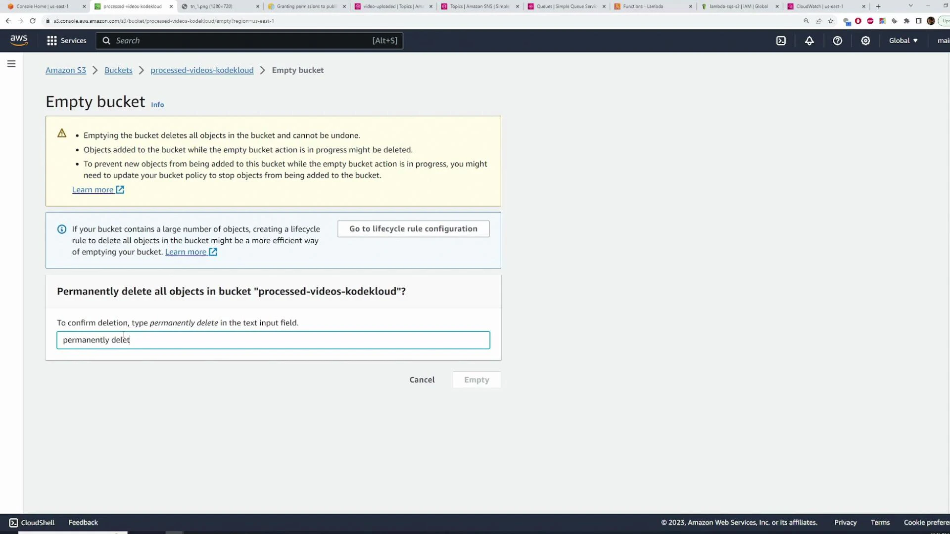 Screenshot of the AWS S3 console showing the "Empty bucket" confirmation for bucket "processed-videos-kodekloud", with a textbox where the user must type "permanently delete" to confirm. The page includes warnings that emptying the bucket deletes all objects and cannot be undone.