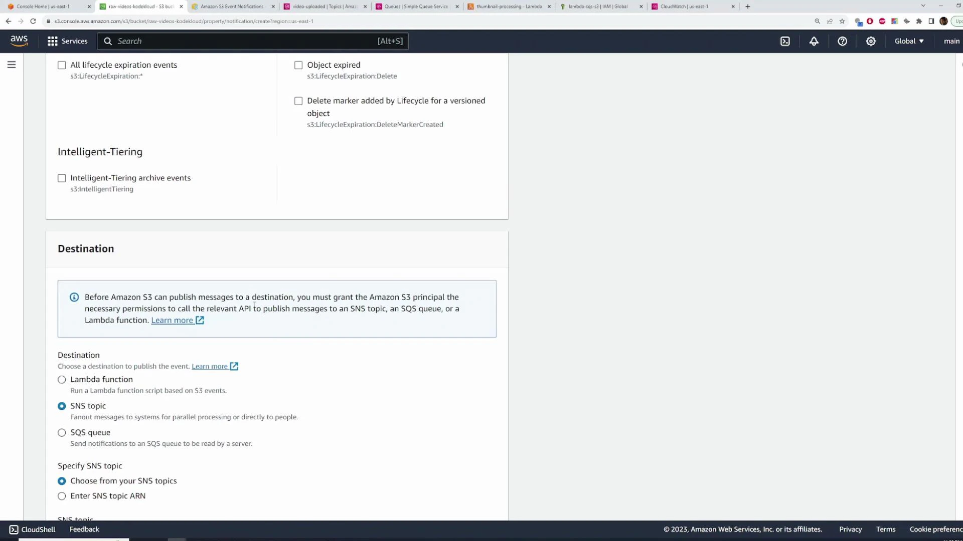 A screenshot of the AWS S3 console showing the "Destination" section for configuring event notifications, with options to choose a Lambda function, SNS topic, or SQS queue and a notice about granting S3 permissions. The top of the page also shows lifecycle/intelligent-tiering event options.