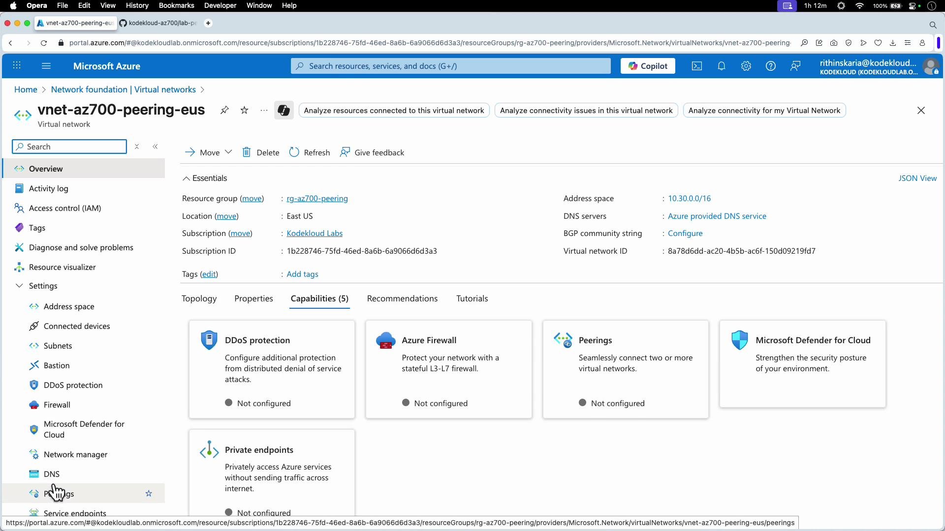 The image is a screenshot of the Microsoft Azure portal, displaying the overview section of a virtual network named "vnet-az700-peering-eus". It includes details such as resource group, location, and various capabilities like DDoS protection and Azure Firewall.
