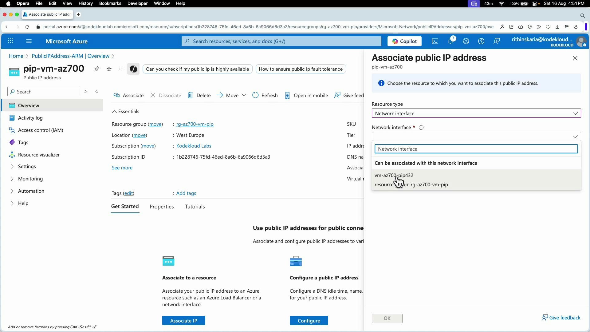 A screenshot of the Microsoft Azure portal showing a Public IP address resource (pip-vm-az700) with the "Associate public IP address" pane open. The pane displays a Resource type of "Network interface" and a dropdown to select a network interface to associate.