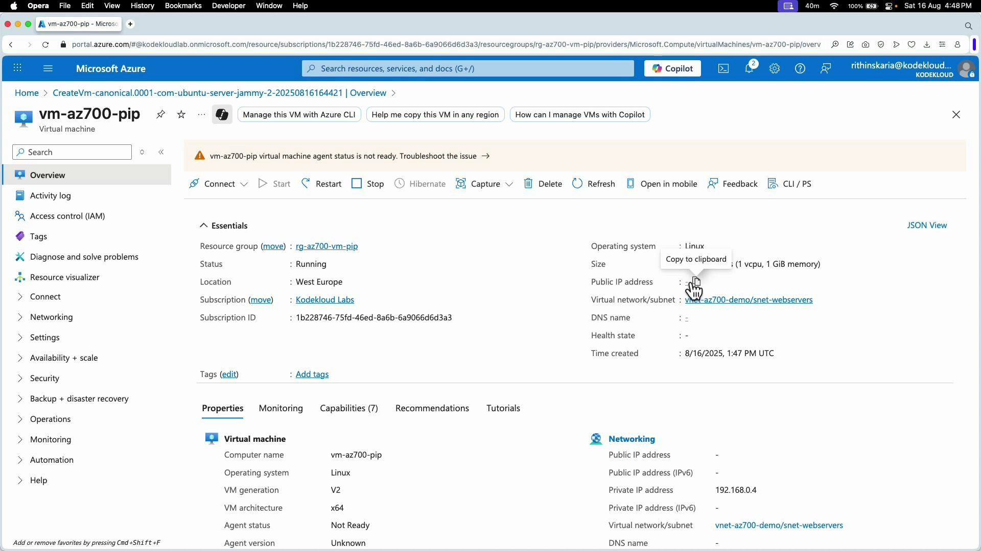 A screenshot of the Microsoft Azure portal showing the overview page for a virtual machine named "vm-az700-pip," with essentials and properties (status, location, subscription, networking) displayed. A warning indicates the VM agent status is not ready and a "Copy to clipboard" tooltip is visible.