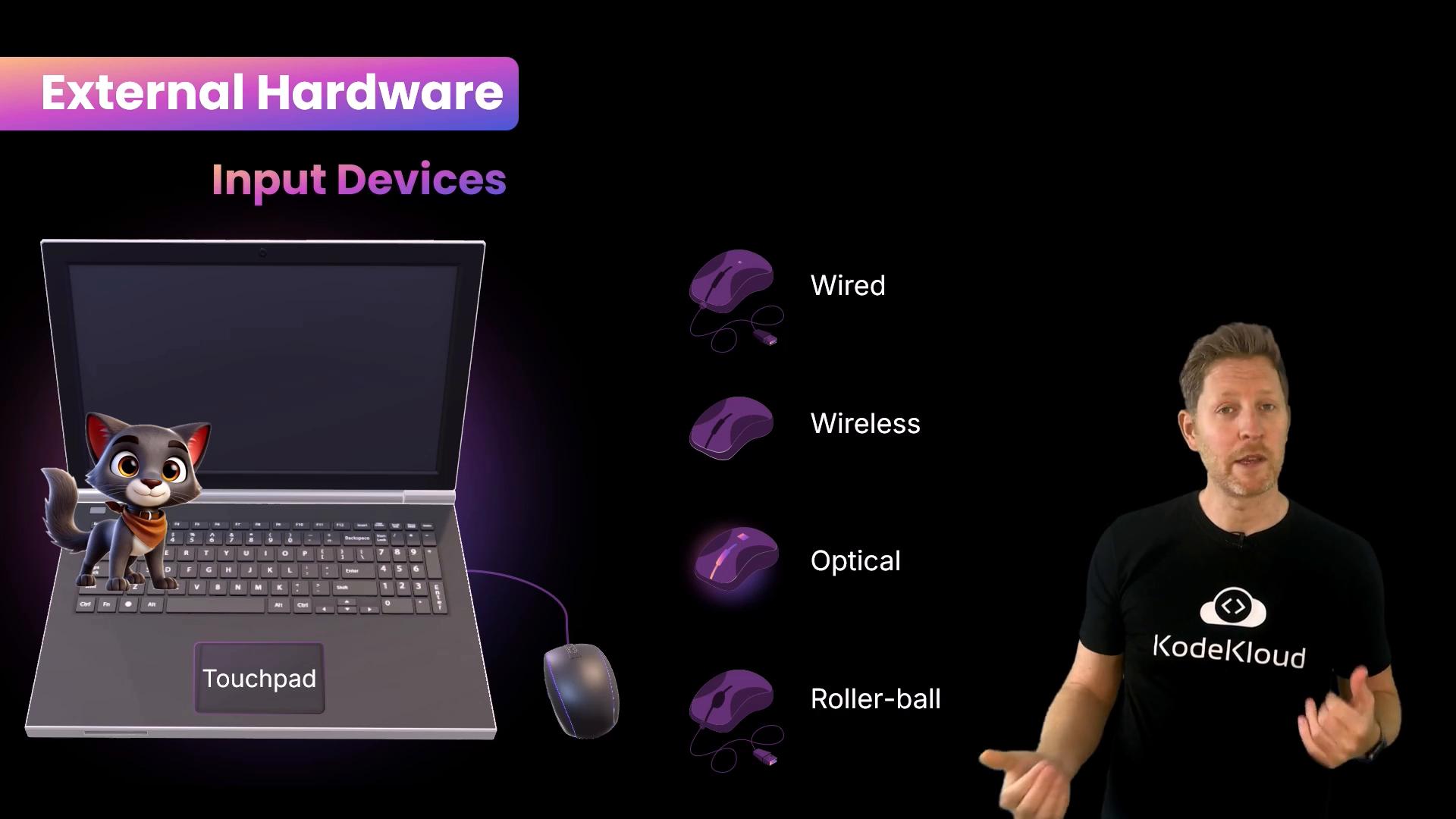 A presentation slide titled "External Hardware: Input Devices" showing a laptop with a cartoon cat on the touchpad and illustrated mice labeled wired, wireless, optical, and roller-ball. A presenter stands at the right wearing a black "KodeKloud" shirt.