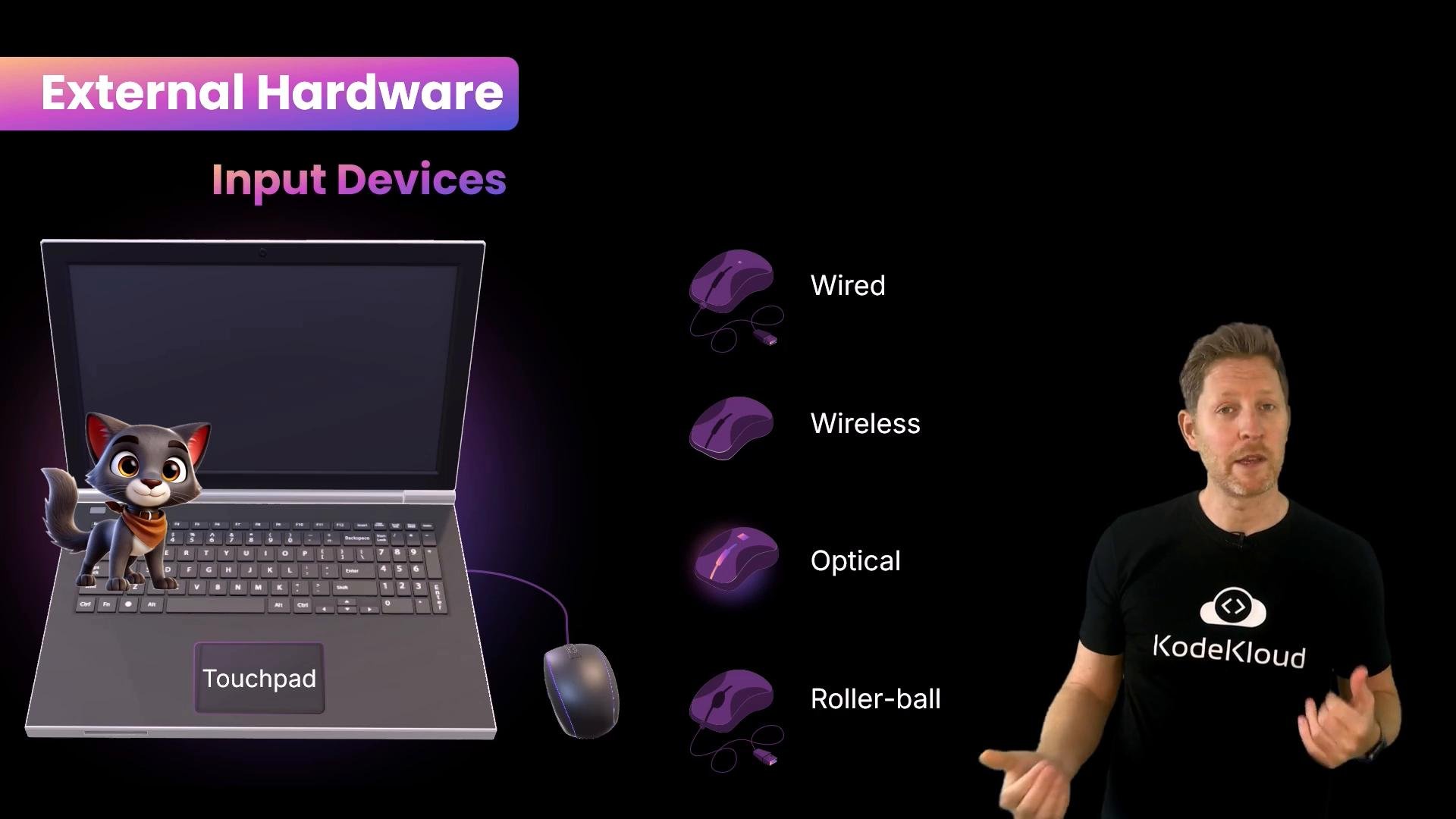 A presentation slide titled "External Hardware: Input Devices" showing a laptop with a cartoon cat on the touchpad and illustrated mice labeled wired, wireless, optical, and roller-ball. A presenter stands at the right wearing a black "KodeKloud" shirt.