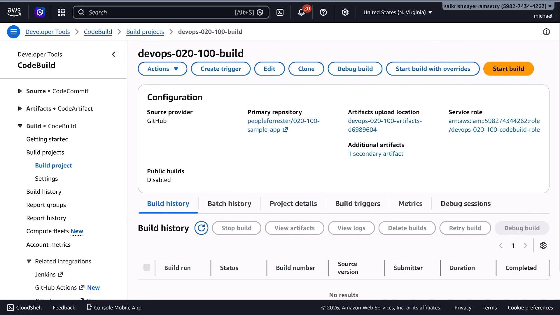 A screenshot of the AWS CodeBuild console showing the project "devops-020-100-build." The page displays configuration details (GitHub source, primary repository, artifacts location, service role) and a Build history panel.