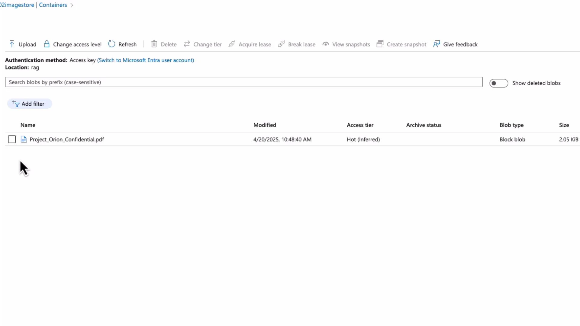 A screenshot of an Azure Blob Storage container UI showing a single file named "Project_Orion_Confidential.pdf" with metadata (modified date, access tier "Hot", blob type "Block blob", size ~2.05 KiB). The top toolbar displays actions like Upload, Change access level, Refresh, and Create snapshot.