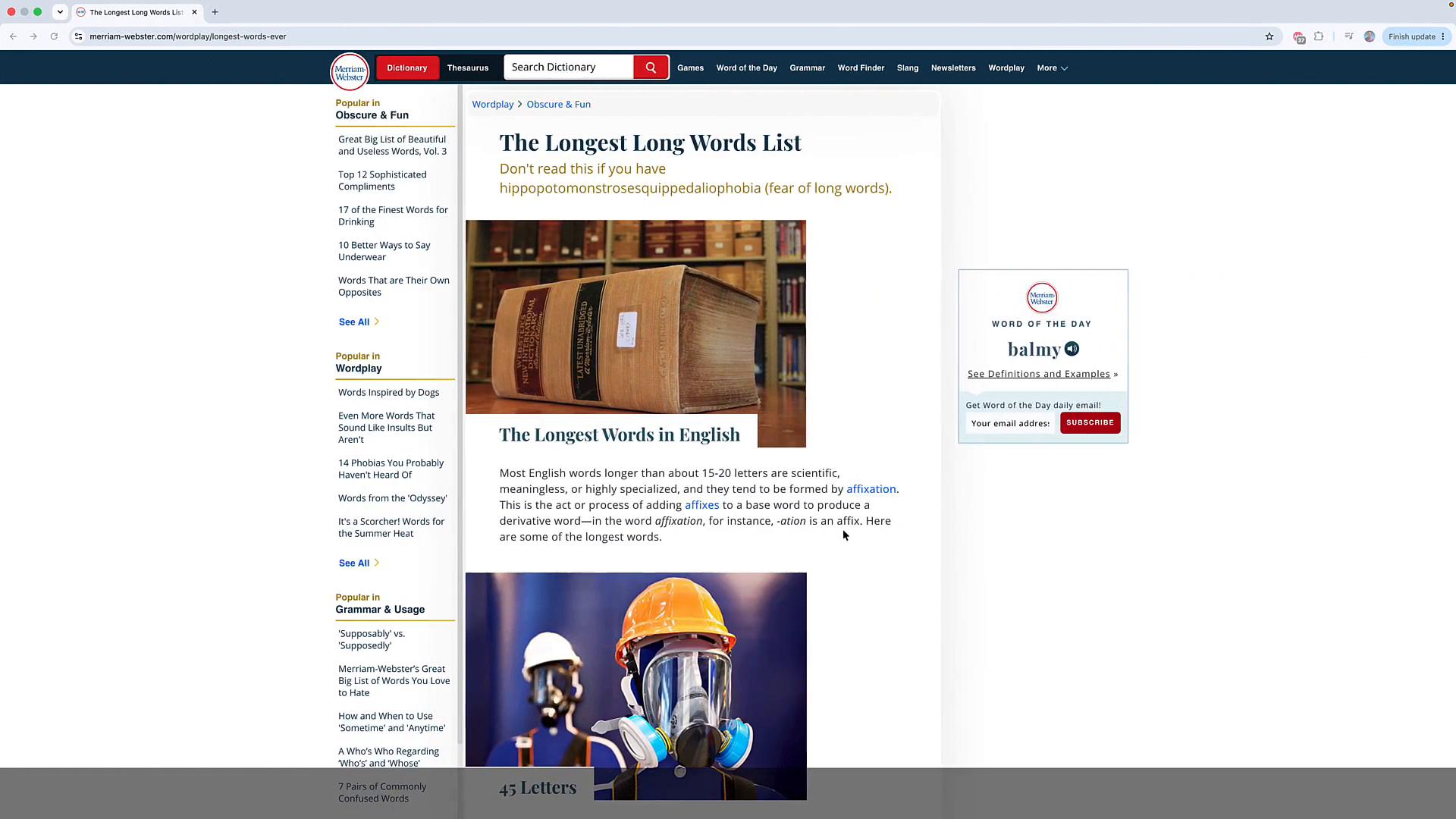 A screenshot of a Merriam‑Webster webpage titled "The Longest Long Words List," showing a photo of a very large reference book on a shelf and, below it, a figure wearing a hard hat and a respirator/gas mask.