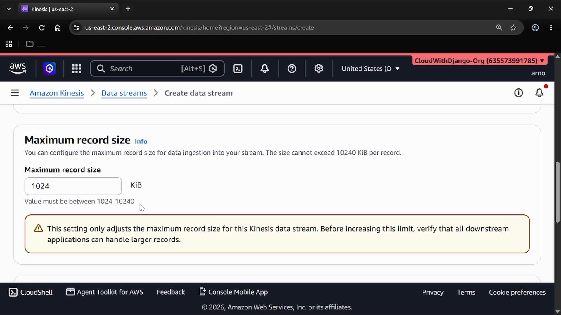 A screenshot of the Amazon Web Services console (Amazon Kinesis — Create data stream) showing the "Maximum record size" setting set to 1024 KiB. A warning box beneath advises verifying downstream applications can handle larger records.