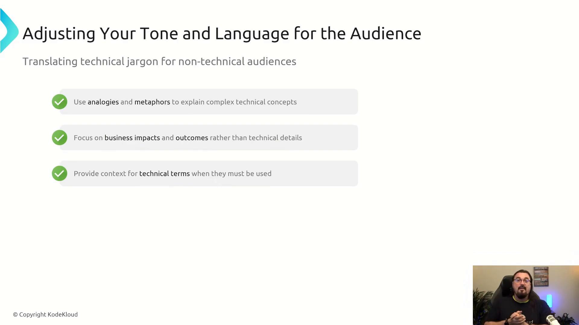 A presentation slide titled "Adjusting Your Tone and Language for the Audience" listing three tips for translating technical jargon—use analogies and metaphors; focus on business impacts and outcomes; and provide context for technical terms. A small webcam video of a speaker appears in the bottom-right corner.