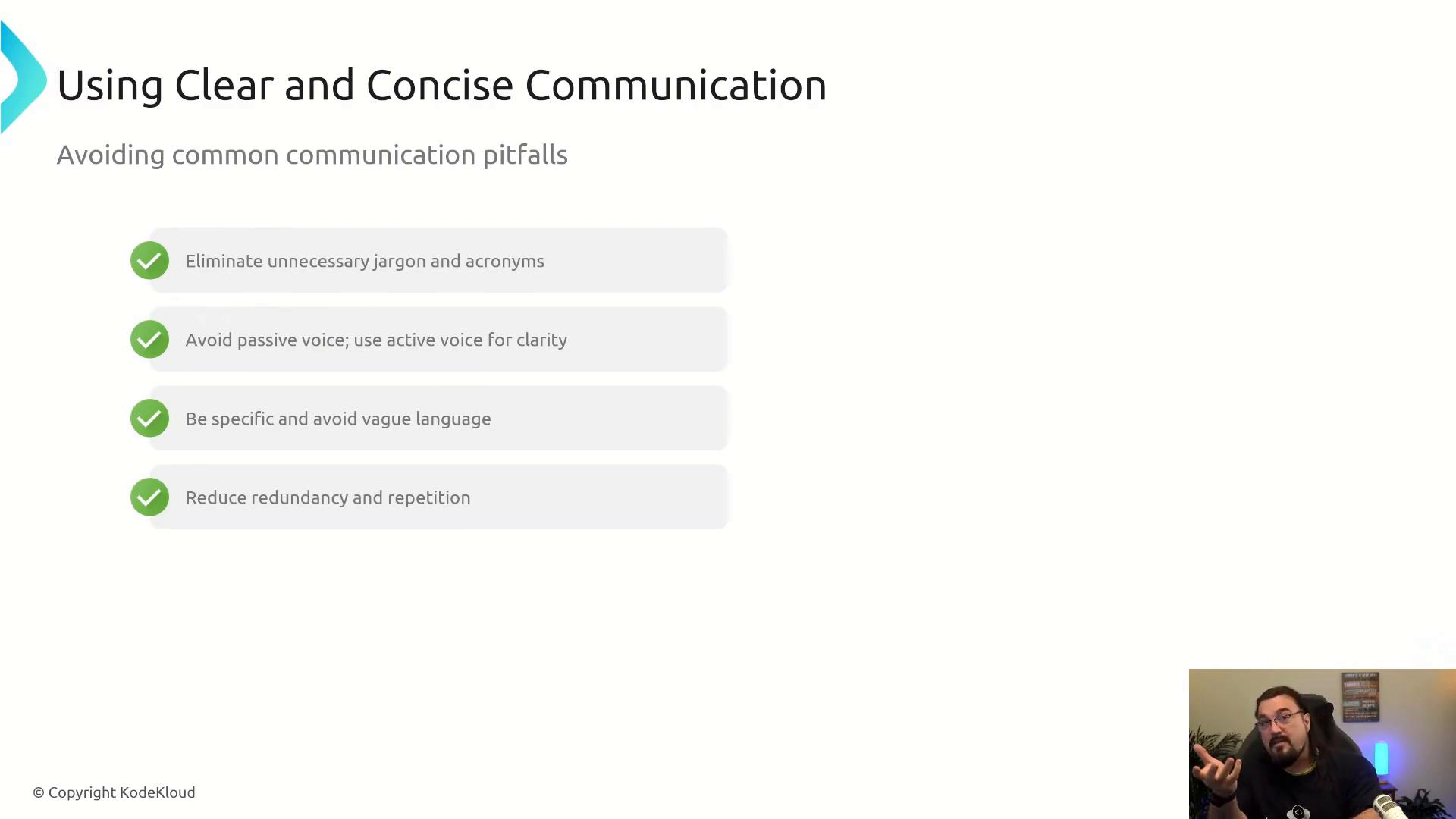 A presentation slide titled "Using Clear and Concise Communication" lists tips like eliminating jargon, using active voice, being specific, and reducing redundancy. A small webcam inset in the bottom-right shows a bearded man gesturing while he speaks.