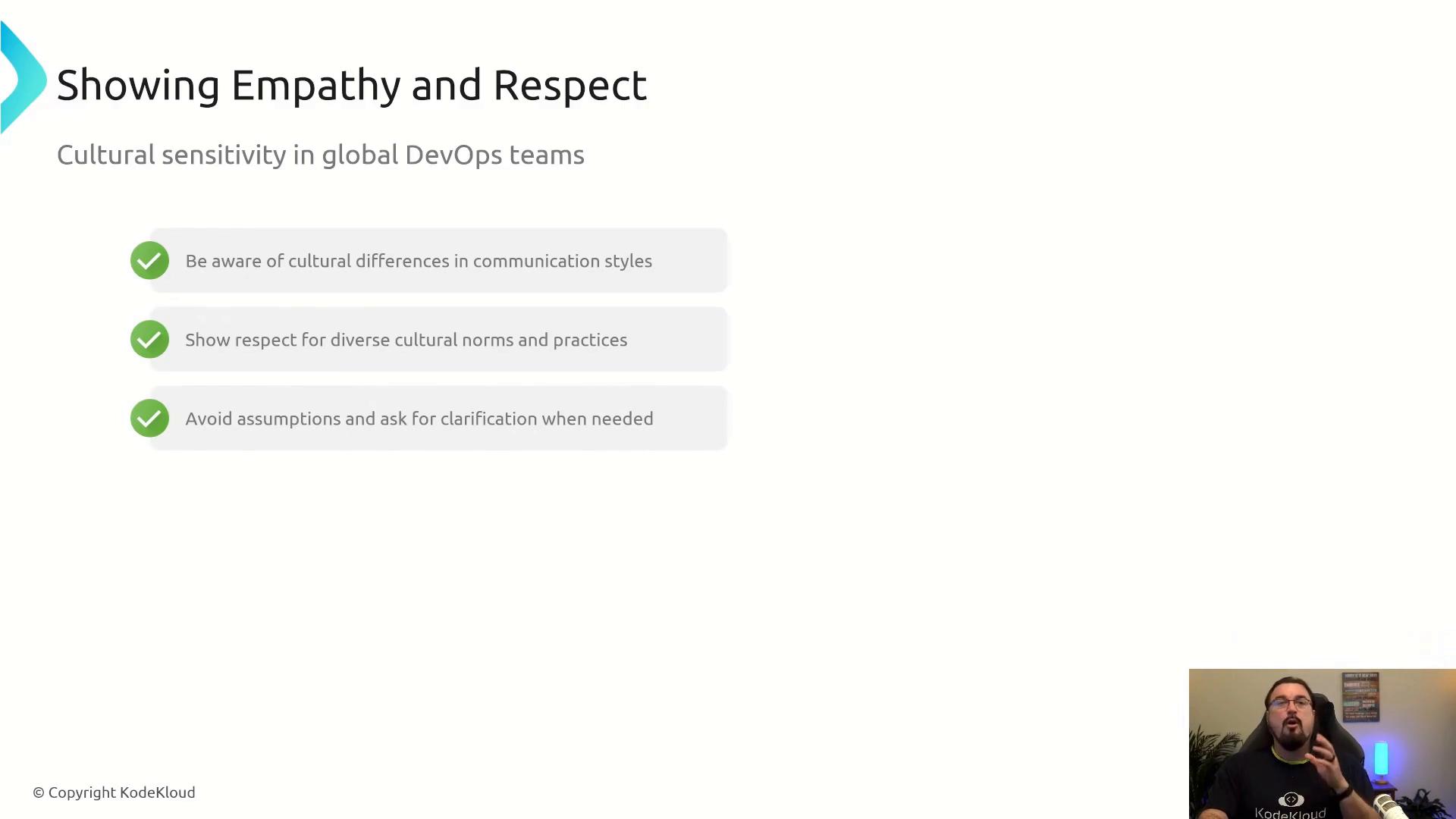 A presentation slide titled "Showing Empathy and Respect" about cultural sensitivity in global DevOps teams, with three tips: be aware of communication differences, show respect for diverse norms, and avoid assumptions by asking for clarification. A small webcam view of the presenter appears in the bottom-right corner.