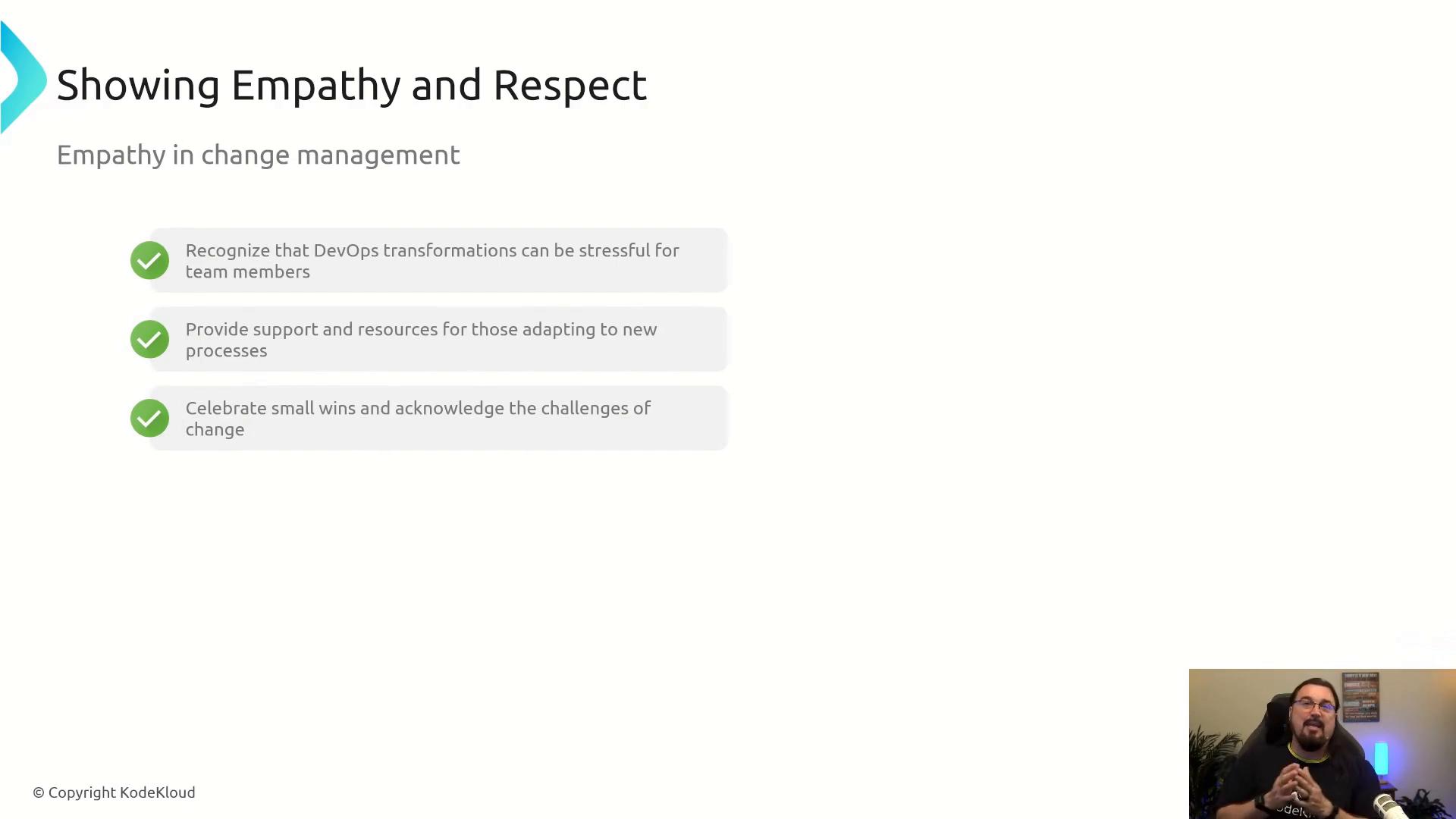 A presentation slide titled "Showing Empathy and Respect" with three bullet points about empathy in change management (acknowledge DevOps stress, provide support/resources, and celebrate small wins). There’s a small video thumbnail of a presenter in the bottom-right corner.
