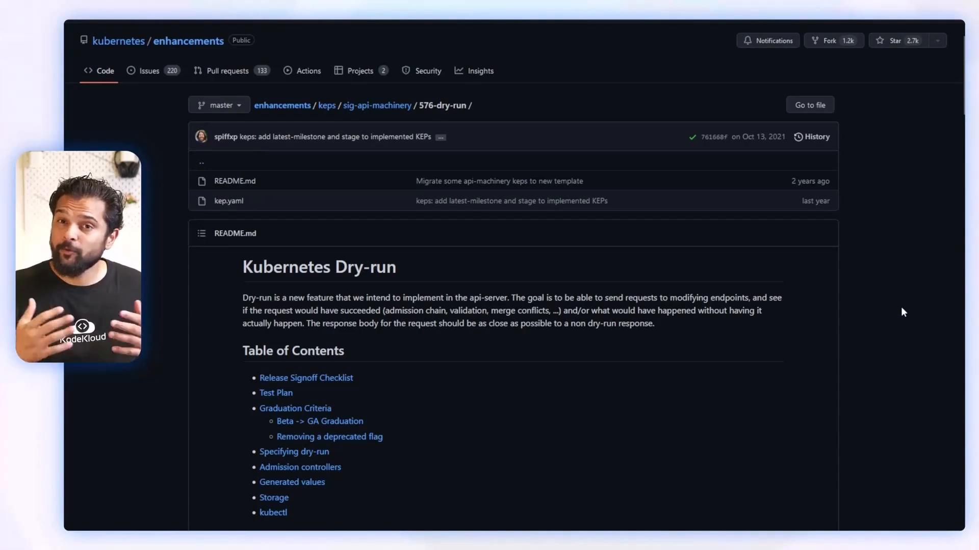 A dark-themed GitHub repository page open to a "Kubernetes Dry-run" README with a table of contents. A small inset video of a man speaking appears on the left.