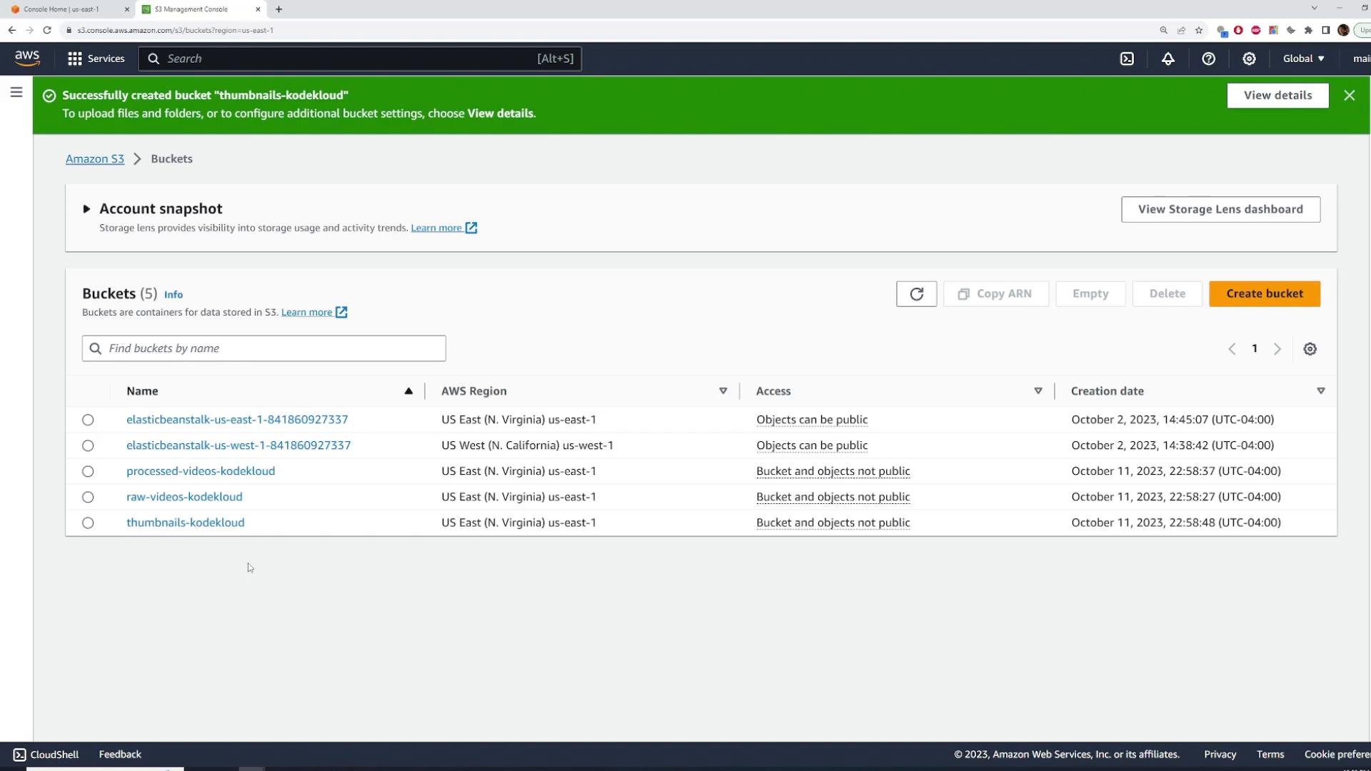 A screenshot of the AWS S3 Management Console showing a list of five S3 buckets (including thumbnails-kodekloud, raw-videos-kodekloud, processed-videos-kodekloud) and a green banner confirming the successful creation of the "thumbnails-kodekloud" bucket. The table displays each bucket's AWS region, access settings, and creation date.