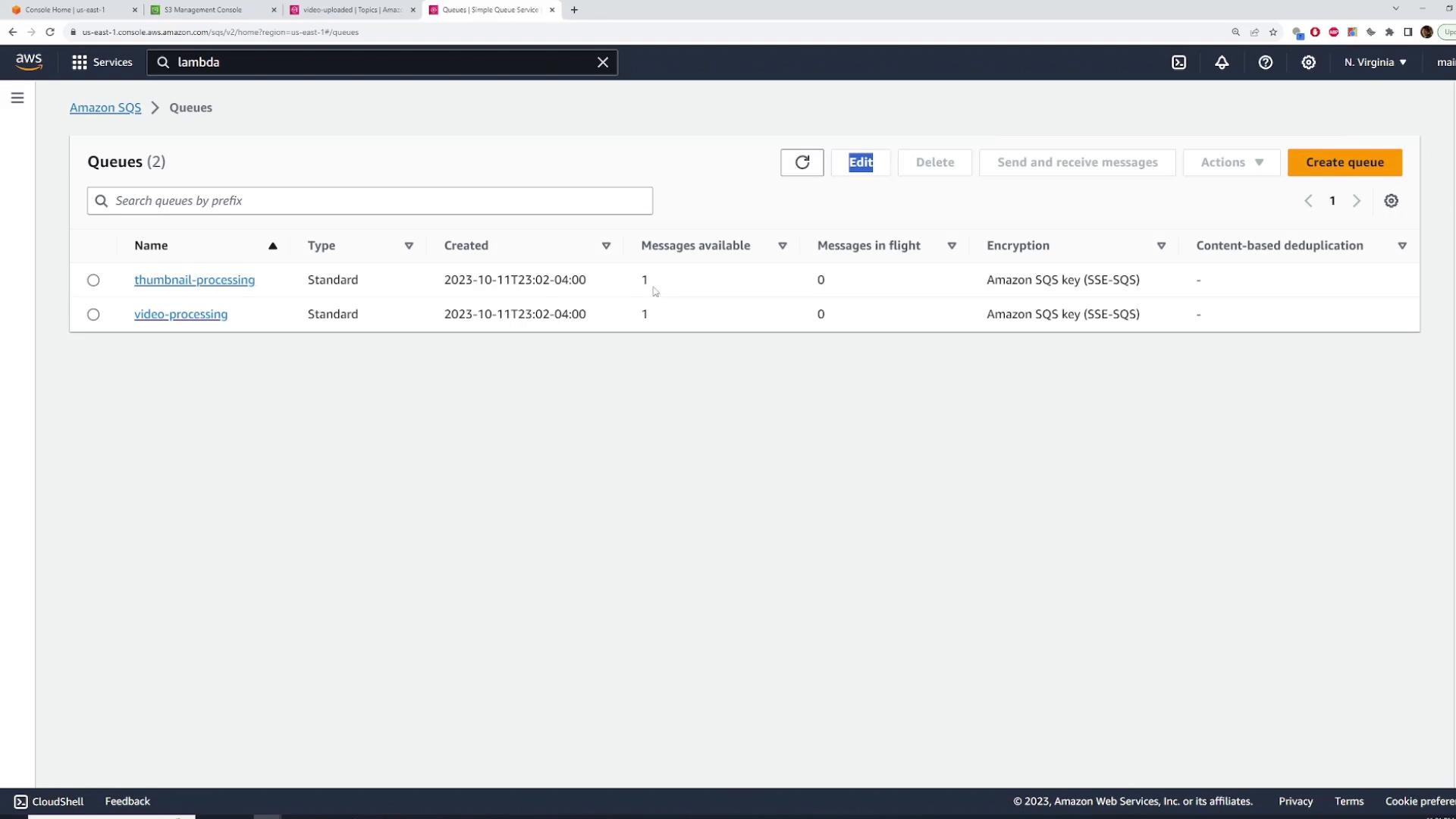 A screenshot of the AWS Simple Queue Service (SQS) console listing two queues: "thumbnail-processing" and "video-processing." Both are Standard queues with one message available each and show creation times and Amazon SQS encryption.