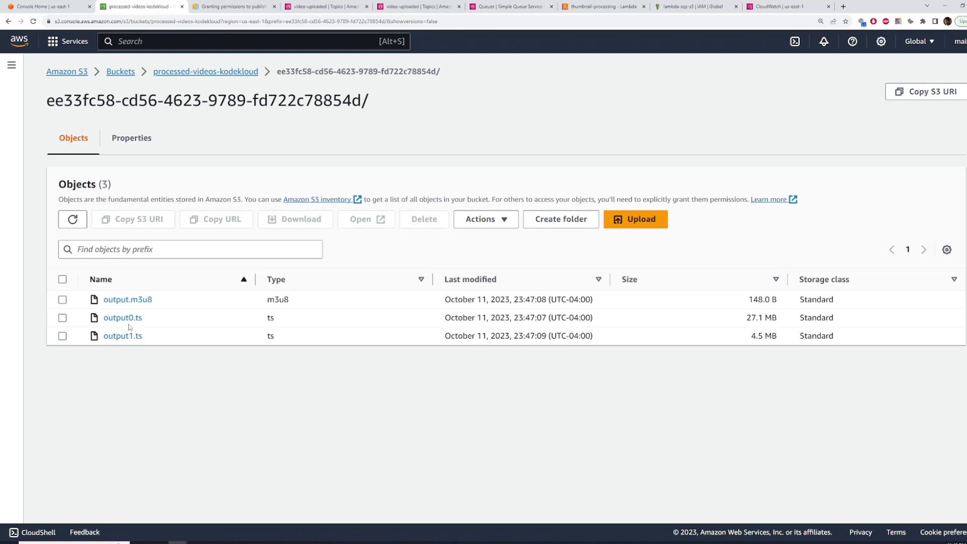 A screenshot of the Amazon S3 web console showing a folder (ID ee33fc58-...) with three objects listed: output.m3u8 and two .ts files. The table shows their types, sizes and last-modified timestamps.