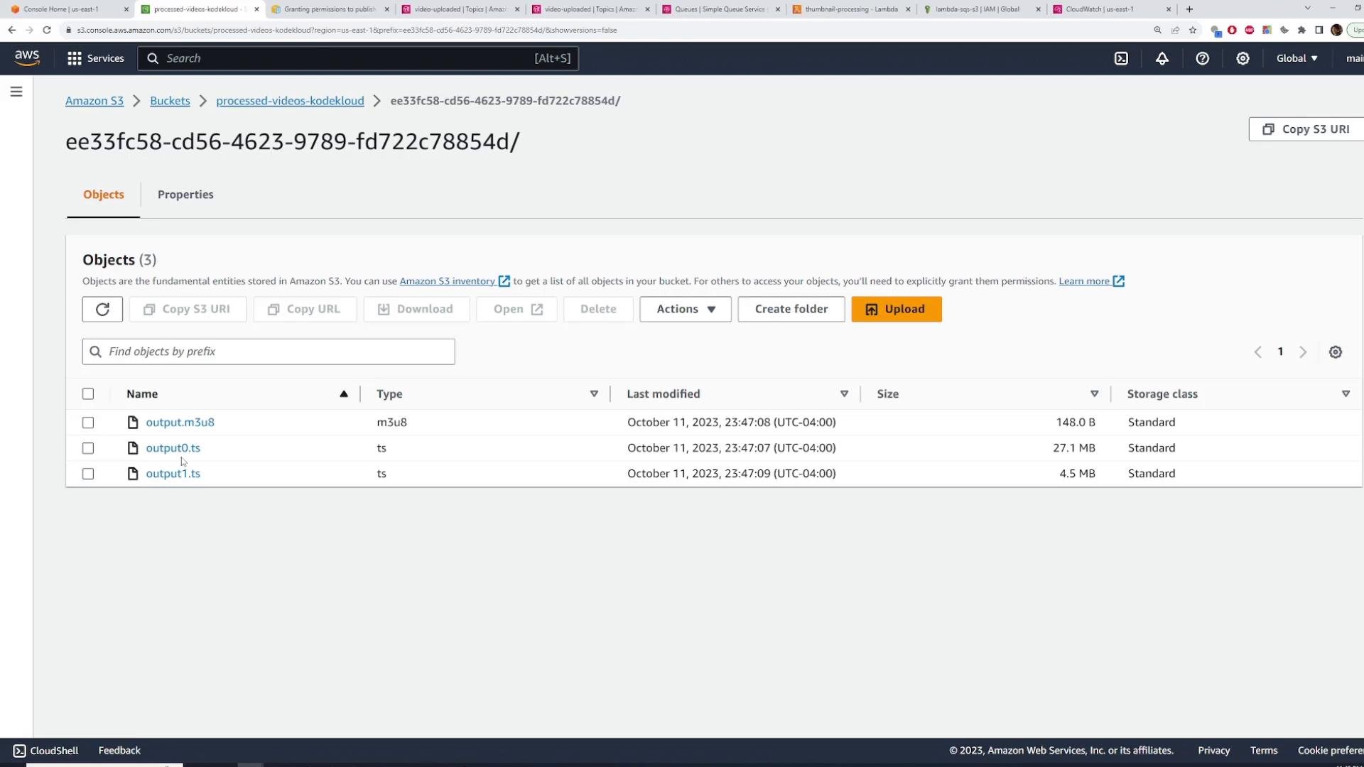 A screenshot of the Amazon S3 web console showing a folder (ID ee33fc58-...) with three objects listed: output.m3u8 and two .ts files. The table shows their types, sizes and last-modified timestamps.