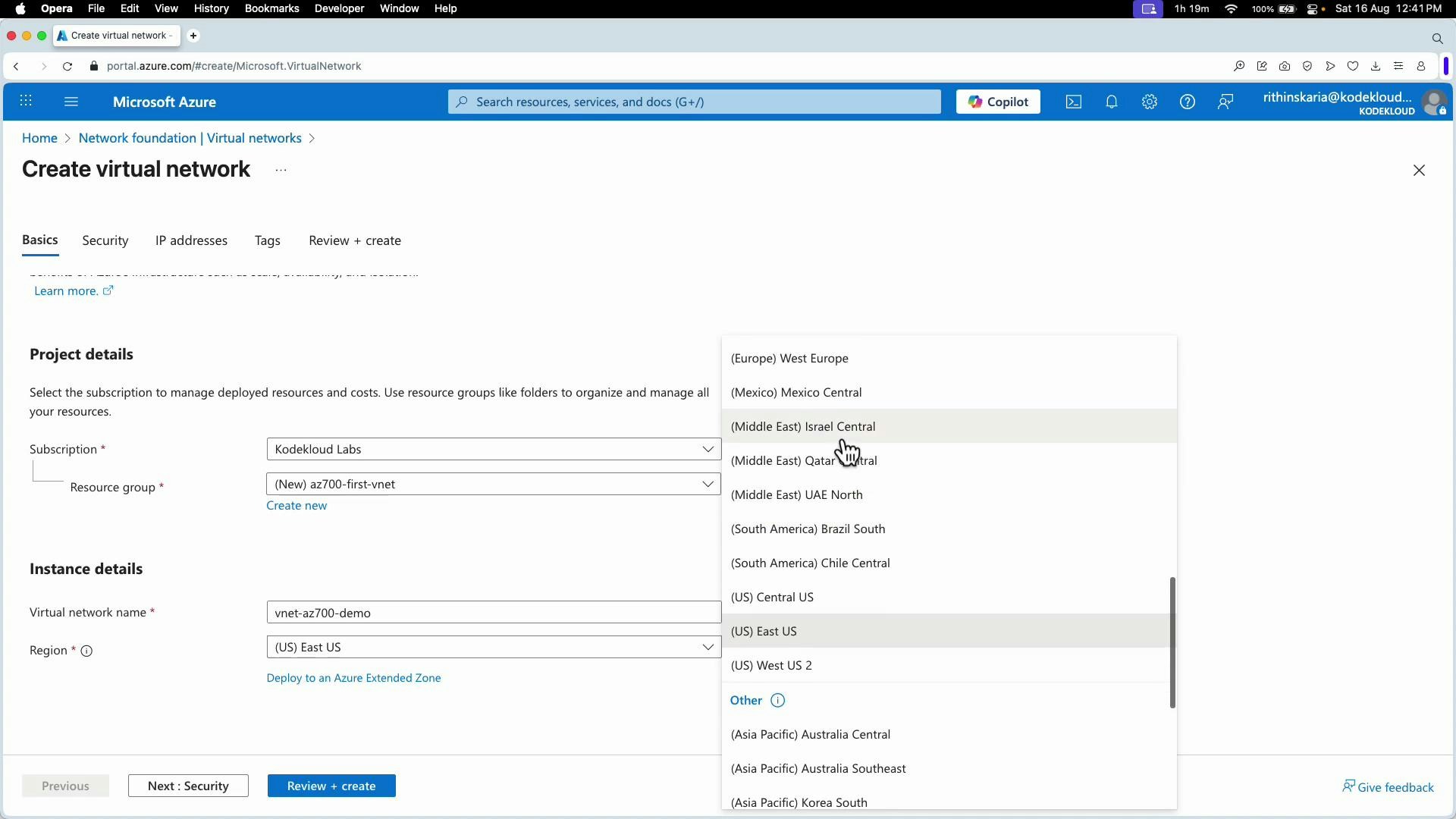 A screenshot of the Microsoft Azure "Create virtual network" page showing Project details and Instance details fields. The Region dropdown is open with various Azure regions listed and action buttons like "Next: Security" and "Review + create" visible.