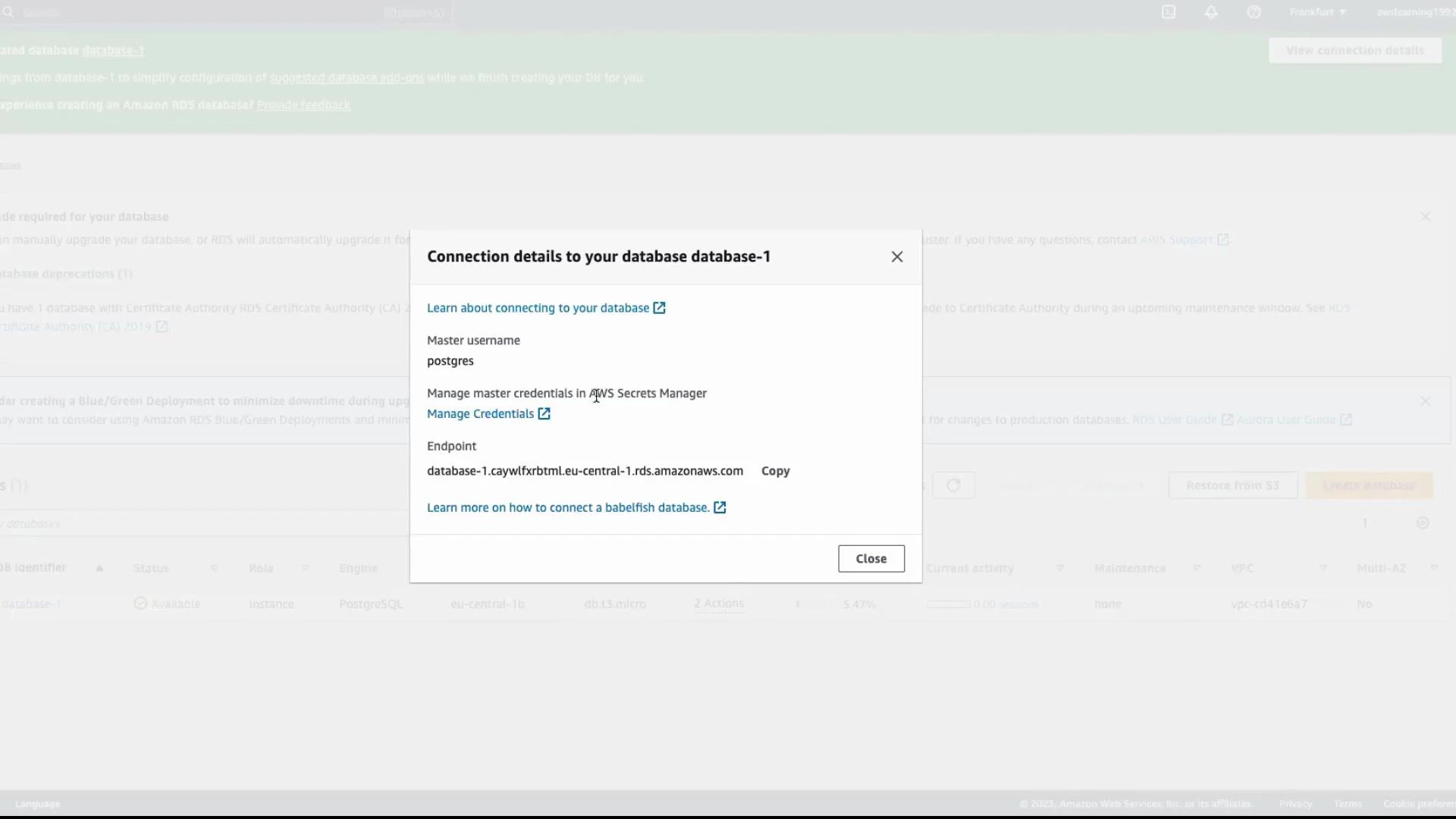 A screenshot of an AWS RDS console dialog titled "Connection details to your database database-1." It shows the master username "postgres," the database endpoint, and links to manage credentials and learn how to connect.