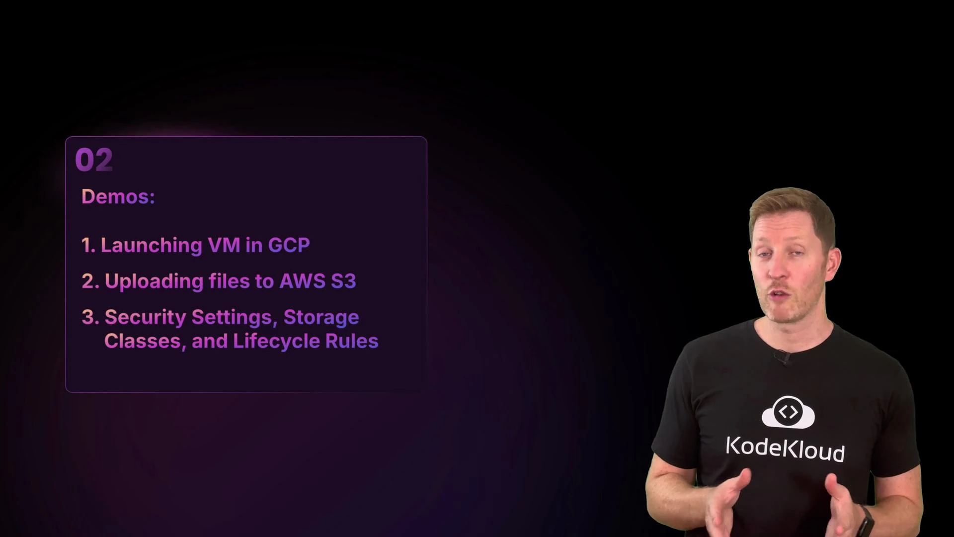 A presenter stands on the right wearing a black KodeKloud t-shirt and gesturing while speaking. On the left is a purple slide titled "Demos" listing: launching a VM in GCP; uploading files to AWS S3; and security settings, storage classes, and lifecycle rules.