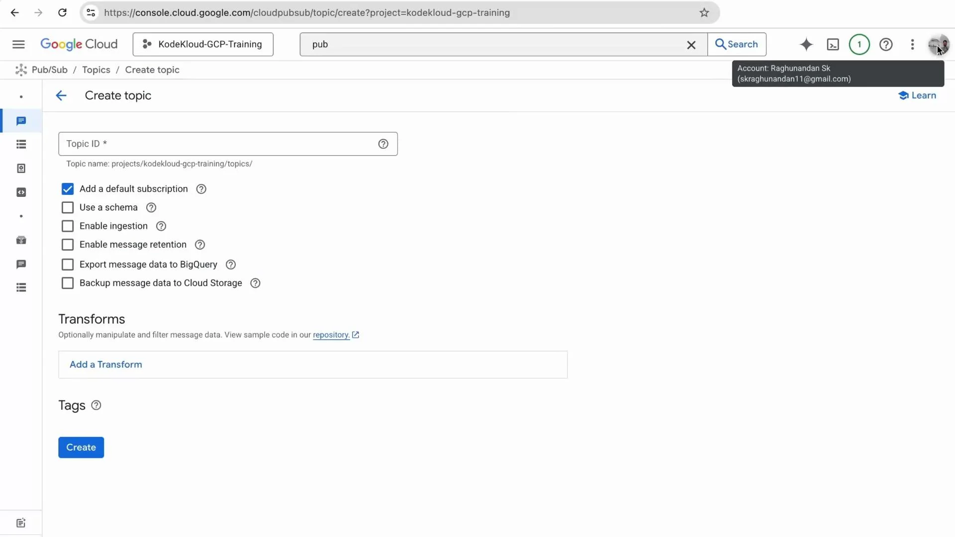 A screenshot of the Google Cloud Console Pub/Sub "Create topic" page showing a Topic ID field and various options (Add a default subscription, use a schema, enable ingestion, export to BigQuery, etc.). A blue "Create" button and a section for Transforms are visible near the bottom.