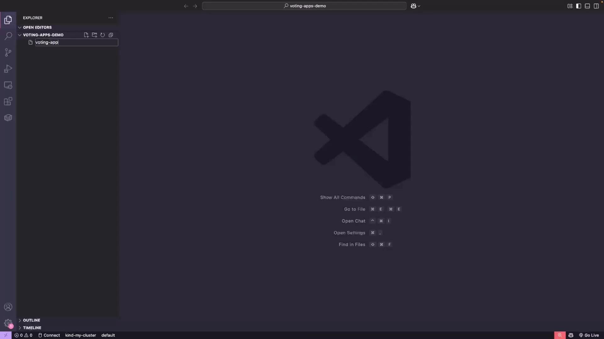 A dark-themed Visual Studio Code window with the Explorer sidebar open showing a folder named "voting-apps-demo" and a file being created called "voting-app". The main area shows the large VS Code logo and quick command hints in the center.