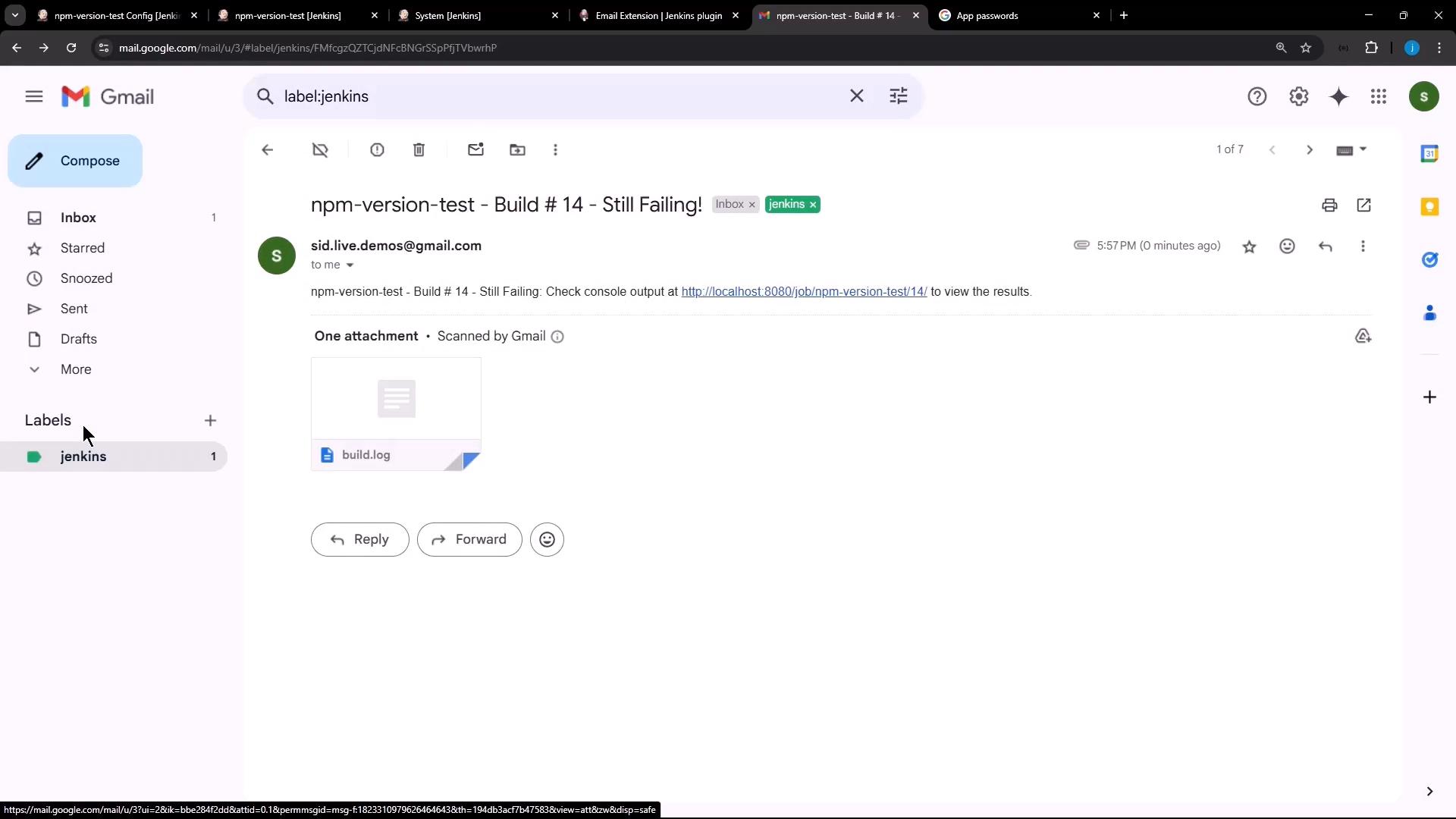 An open Gmail message with the subject "npm-version-test - Build #14 - Still Failing!" showing a build.log attachment. The email body includes a link to a Jenkins job (localhost).