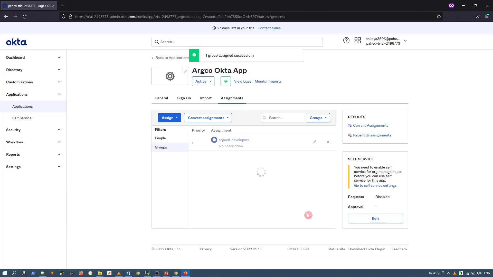 A screenshot of the Okta admin console showing the "Argco Okta App" details on the Assignments tab, with a group ("argocd-developers") assigned. The left sidebar shows navigation options like Dashboard, Directory, and Applications.