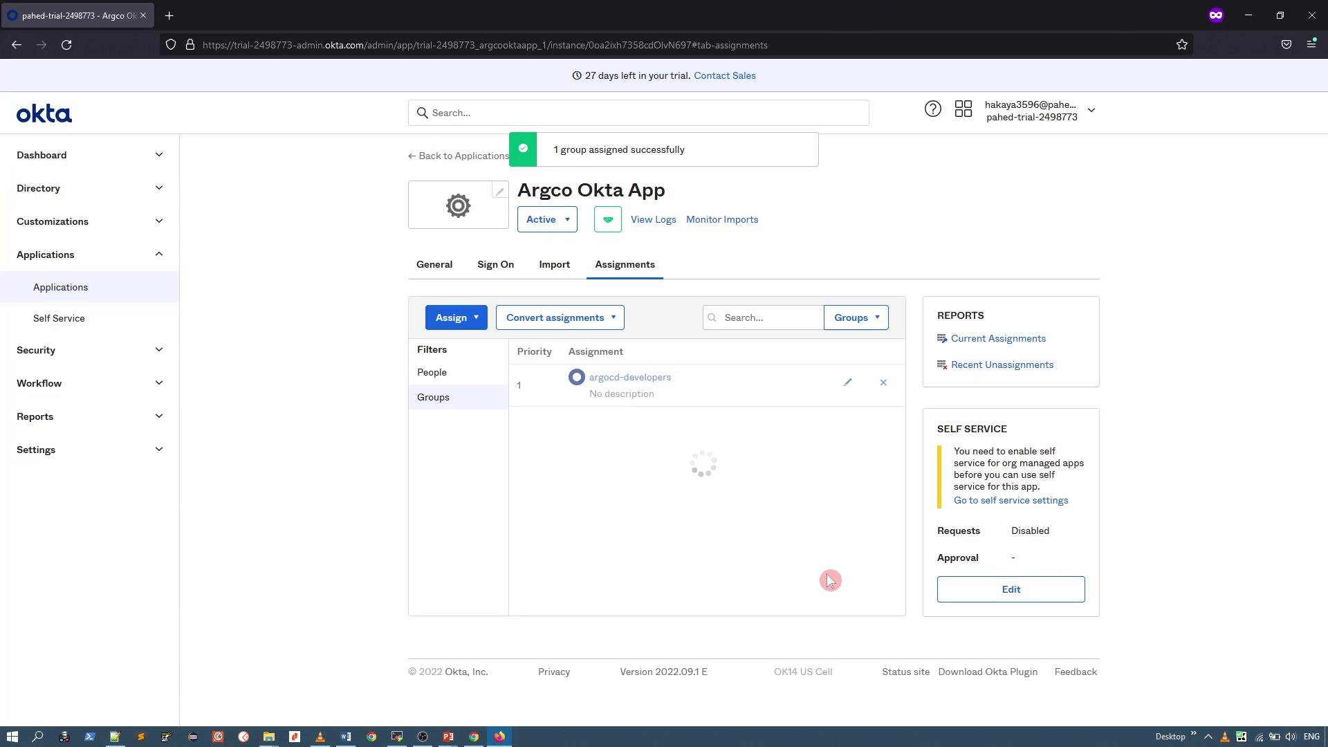 A screenshot of the Okta admin console showing the "Argco Okta App" details on the Assignments tab, with a group ("argocd-developers") assigned. The left sidebar shows navigation options like Dashboard, Directory, and Applications.