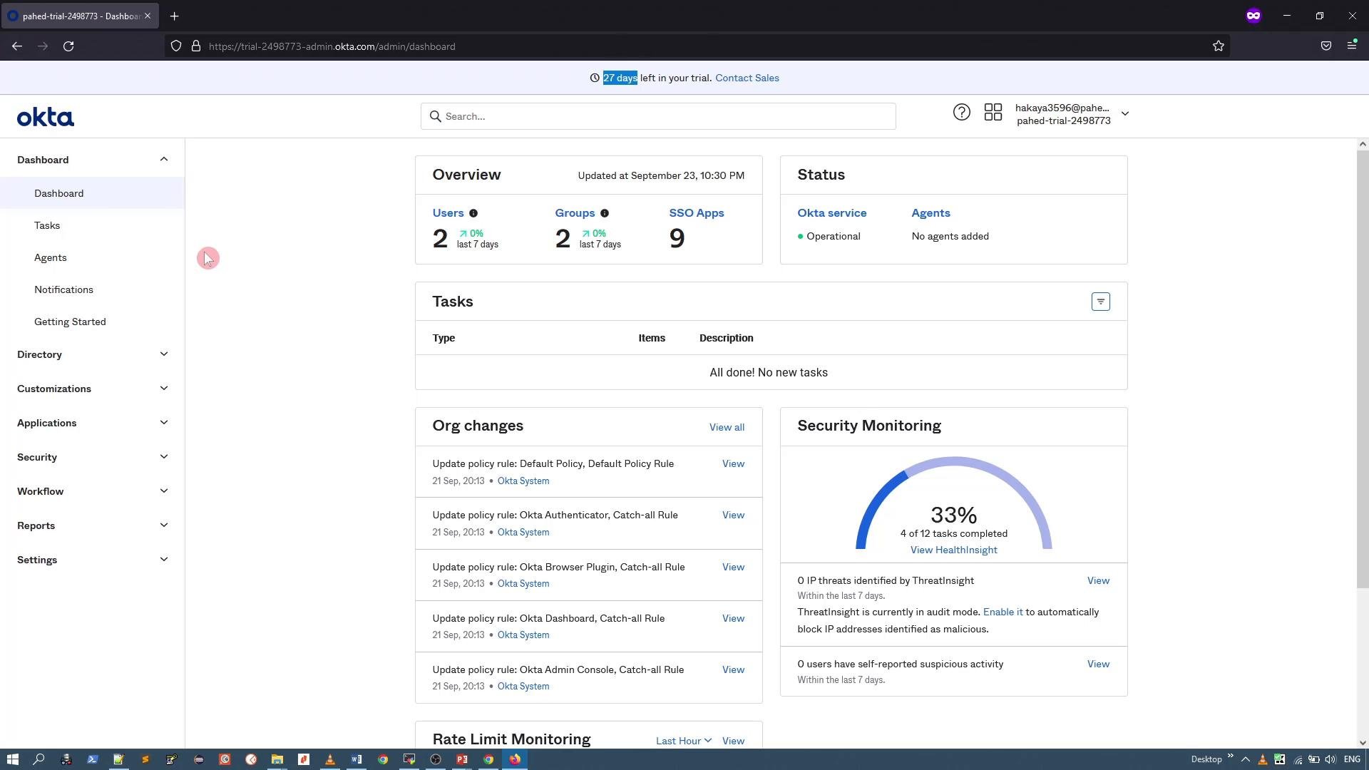A screenshot of the Okta admin dashboard web interface showing an Overview panel with users, groups and SSO apps and a Status panel. The left navigation menu and sections for Tasks, Org changes, and Security Monitoring (33% complete) are also visible.