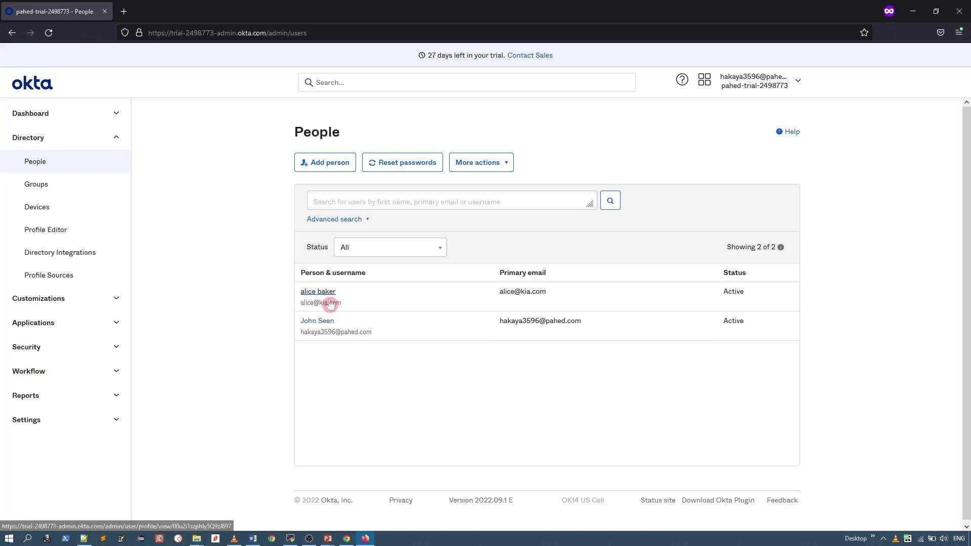 A screenshot of the Okta admin console showing the "People" directory. The main panel lists two user accounts with their email/status columns and action buttons, while a navigation sidebar appears on the left.