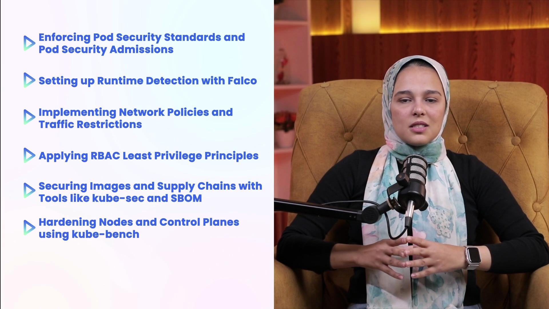 The image shows a person speaking into a microphone, seated on a chair with a list of security-related topics displayed on the side.