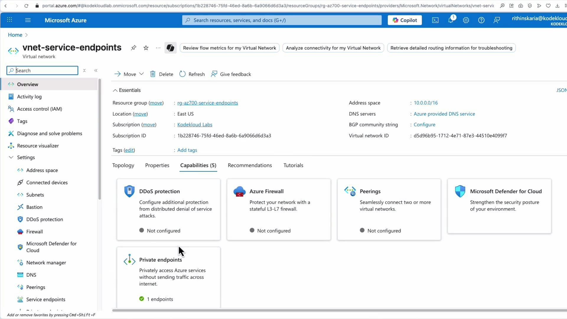 A screenshot of the Microsoft Azure portal displaying the "vnet-service-endpoints" virtual network overview, showing essentials (resource group, location, address space) and the Capabilities tab with items like DDoS protection, Azure Firewall, Peerings and Private endpoints. The left sidebar shows navigation options such as Subnets, DNS, Peering and Service endpoints.
