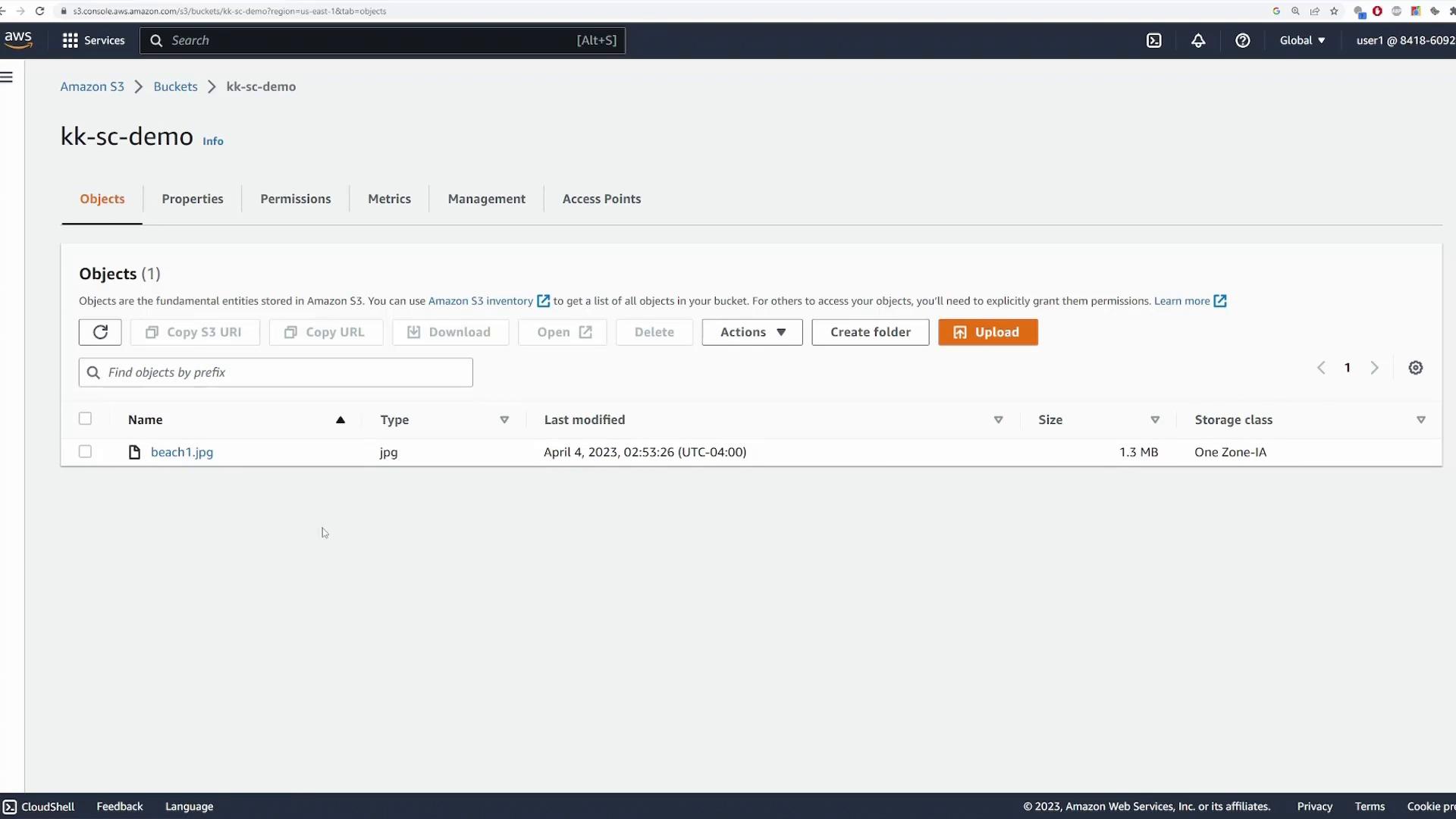 Screenshot of the Amazon S3 console for the bucket "kk-sc-demo" with the Objects tab open. It shows one file listed named "beach1.jpg" (1.3 MB, One Zone-IA) and controls like Upload and Create folder.
