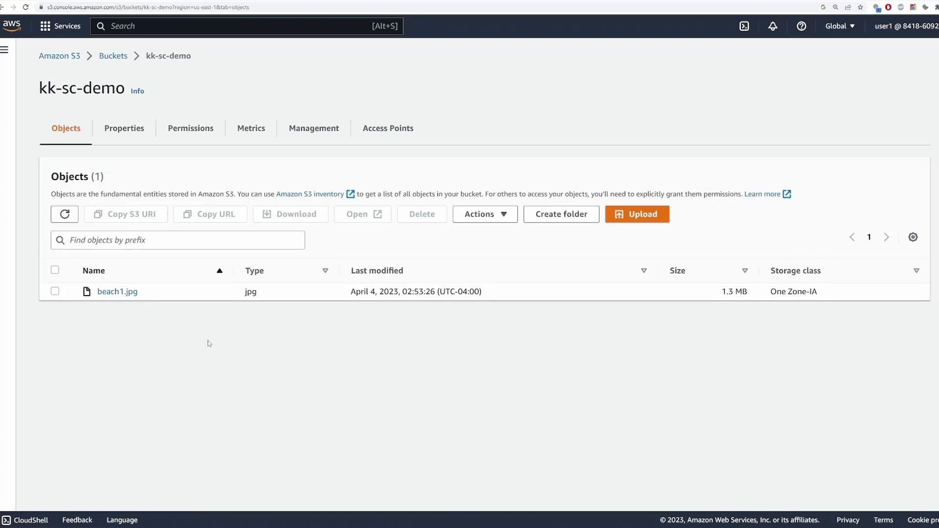Screenshot of the Amazon S3 console for the bucket "kk-sc-demo" with the Objects tab open. It shows one file listed named "beach1.jpg" (1.3 MB, One Zone-IA) and controls like Upload and Create folder.