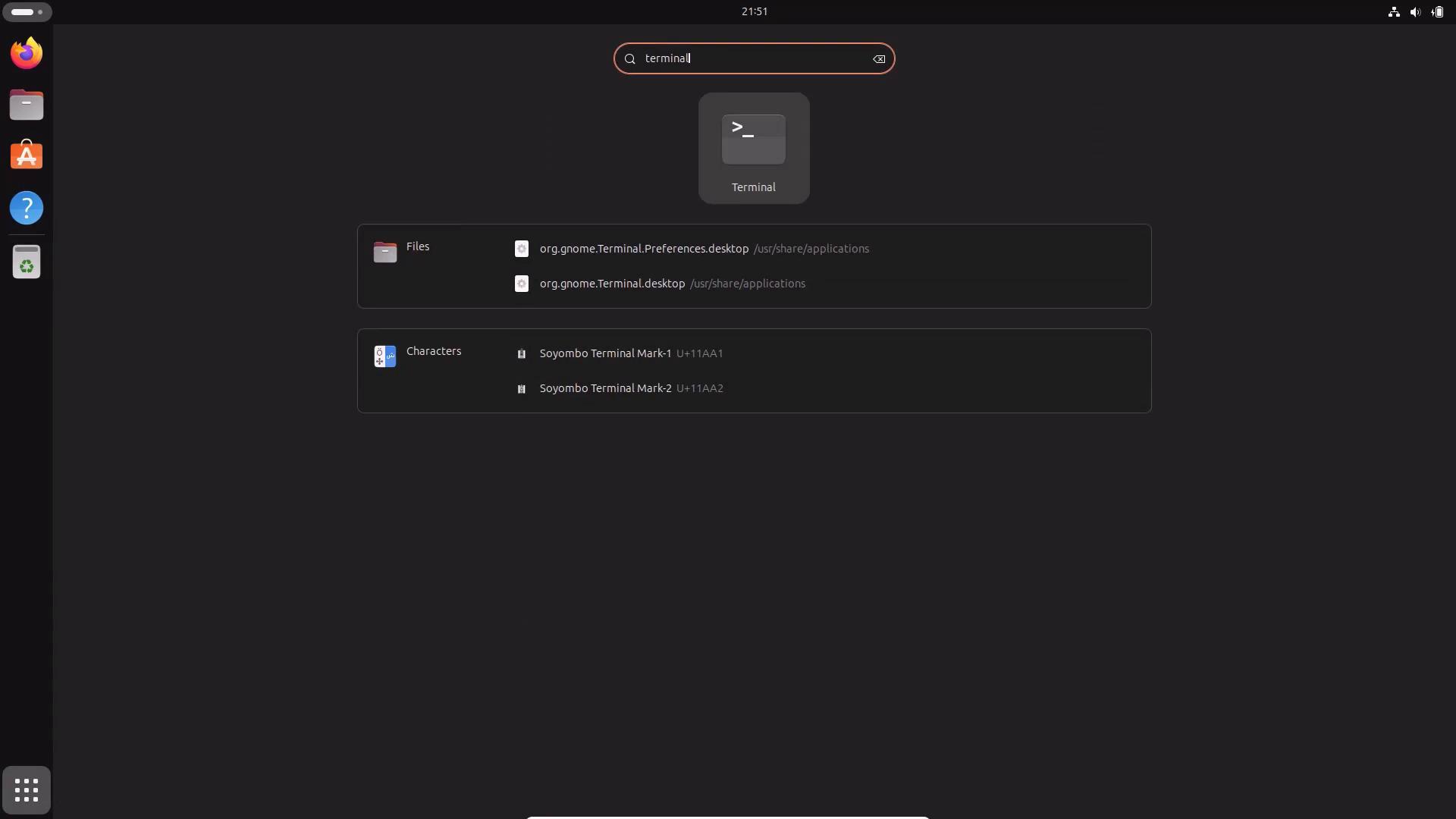 A dark GNOME desktop overview with the search box querying "terminal," showing the Terminal app icon and matching results in the center and a left-side dock of app icons. The top bar with the time is visible at the top.