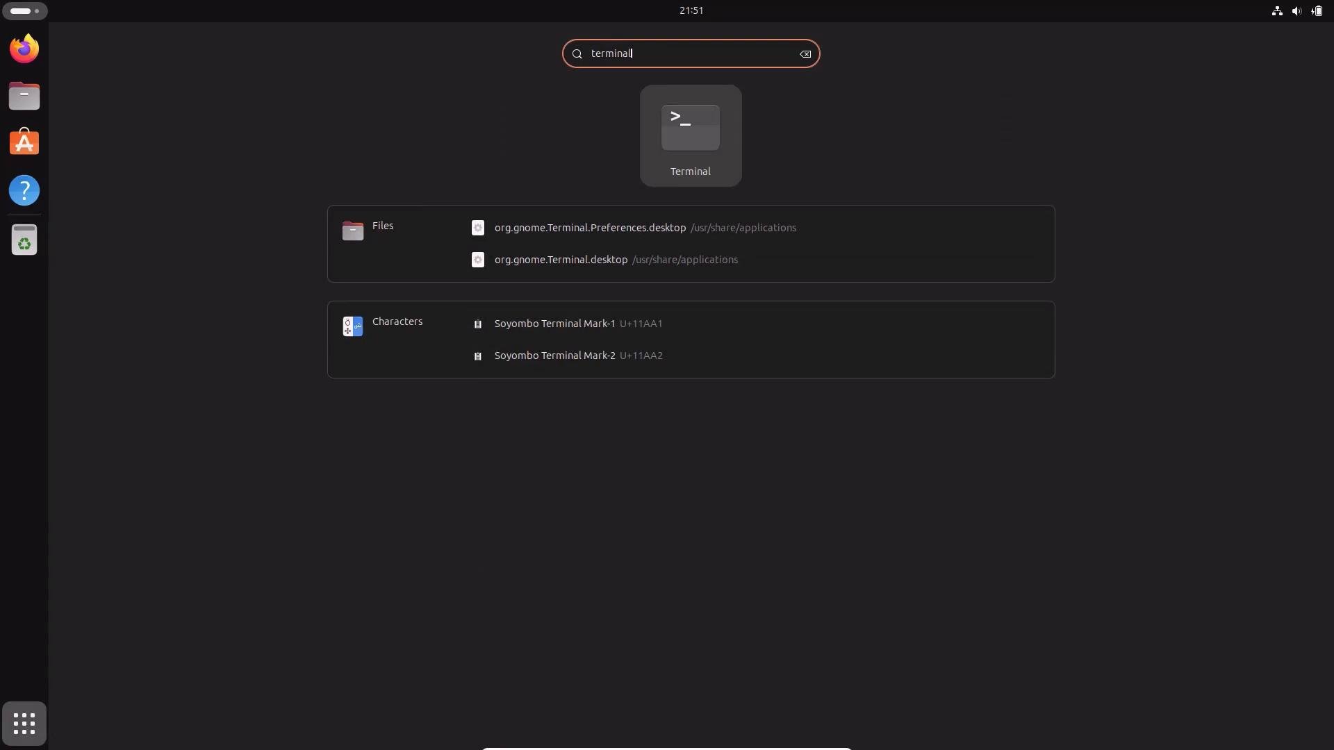 A dark GNOME desktop overview with the search box querying "terminal," showing the Terminal app icon and matching results in the center and a left-side dock of app icons. The top bar with the time is visible at the top.