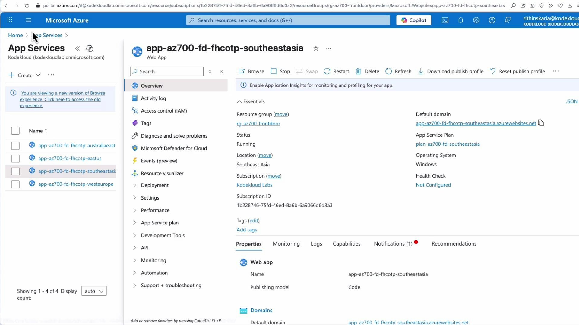 A screenshot of the Microsoft Azure portal showing the App Services view. It displays the overview and essentials for a web app named "app-az700-fd-fhcotp-southeastasia," including resource group, status, location, subscription, and default domain.