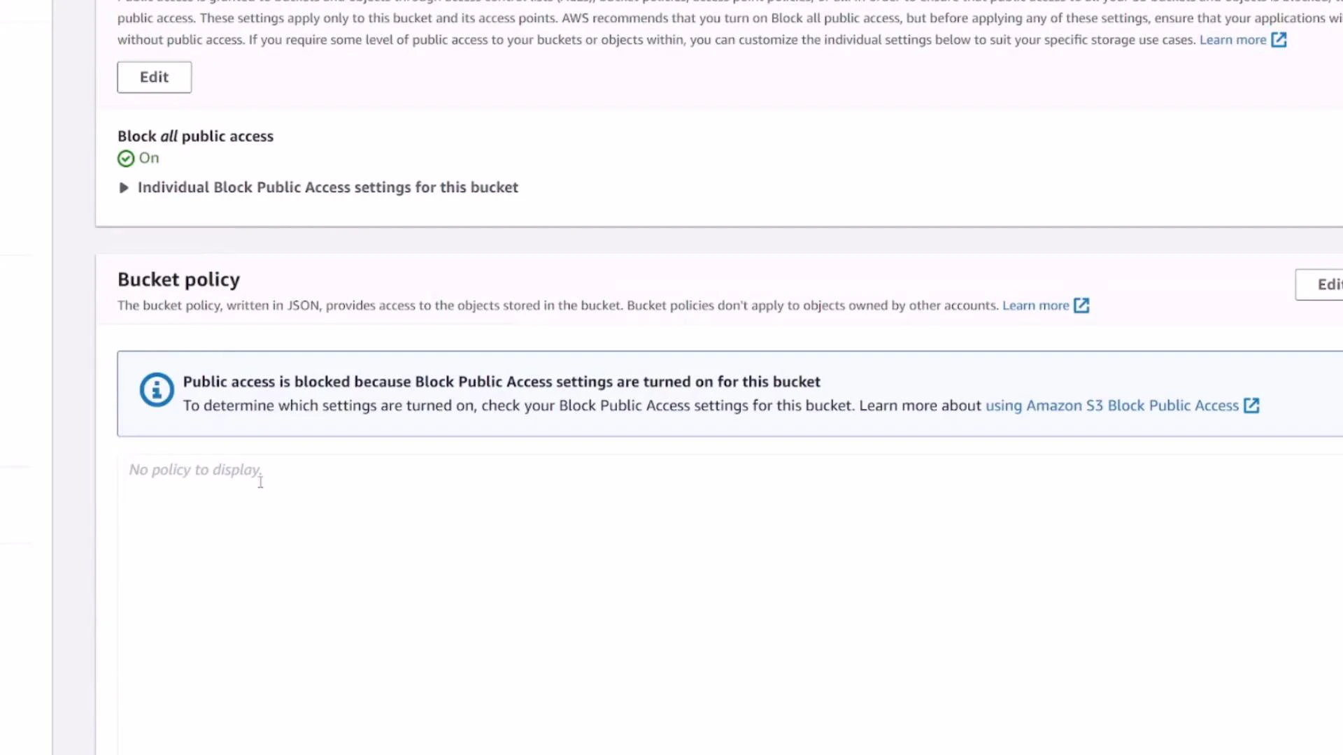 A screenshot of an AWS S3 bucket settings page showing the "Block all public access" option turned on. The Bucket policy section states public access is blocked and shows "No policy to display."