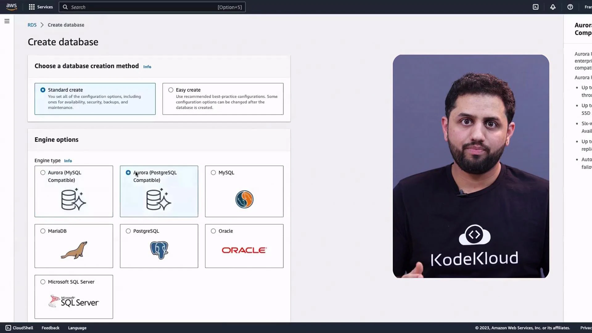 A screenshot of the AWS RDS "Create database" console showing database creation methods and engine options, with Aurora (PostgreSQL) selected. On the right is a video/photo frame of a person wearing a "KodeKloud" t‑shirt.
