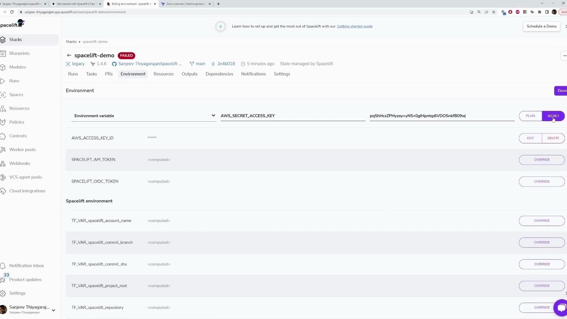 A screenshot of the Spacelift web UI on the "Environment" tab showing a list of environment variables (e.g., AWS_ACCESS_KEY_ID, AWS_SECRET_ACCESS_KEY, SPACELIFT_API_TOKEN) with a secret value entered and the "SECRET" toggle selected. The left sidebar shows navigation items like Stacks, Blueprints, Modules, Runs, and Settings.