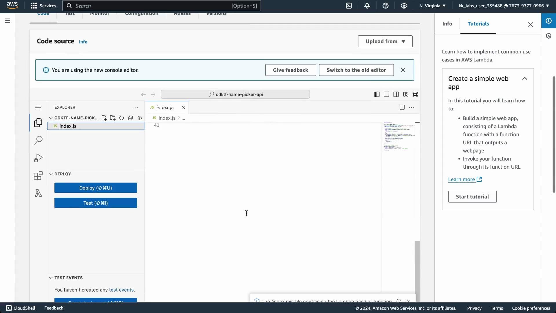 A screenshot of the AWS Lambda console showing the built-in code editor with index.js open in the Explorer pane, Deploy and Test buttons on the left, and a "Create a simple web app" tutorial panel on the right. The top banner notes the new console editor and offers a switch to the old editor.
